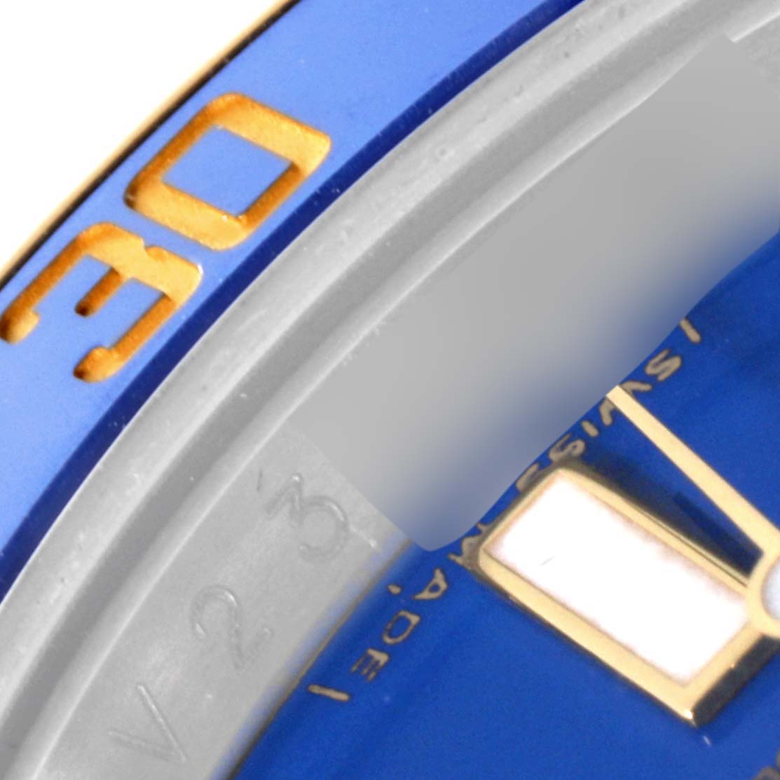 The image shows a close-up of the bezel and part of the dial of a Rolex Submariner 116613LB Men's Steel and Gold (two tone) Blue Dial 116613LB Men's Steel and Gold (two tone) Blue Dial watch.