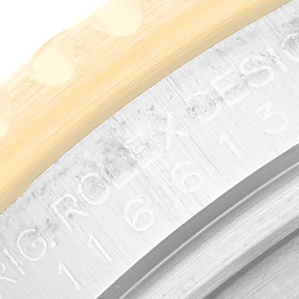 This image shows a close-up of the side of a Rolex Submariner 116613LB Men's Steel and Gold (two tone) Blue Dial 116613LB Men's Steel and Gold (two tone) Blue Dial watch, focusing on the engraved model number and part of the bezel.