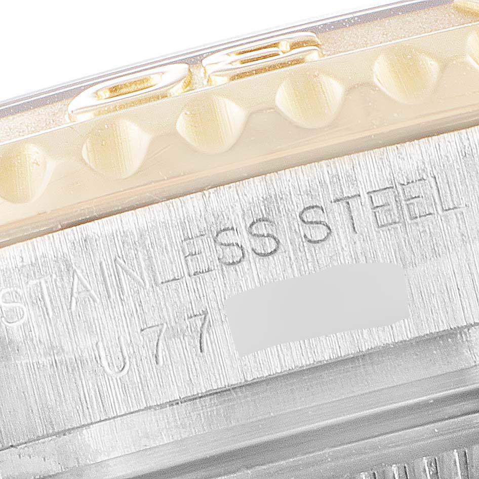 This close-up shows part of the bezel and the casing inscription of a Rolex Yacht-Master 69623 Women's Steel and Gold (two tone) White Dial 69623 Women's Steel and Gold (two tone) White Dial watch, highlighting the "STAINLESS STEEL" engraving.