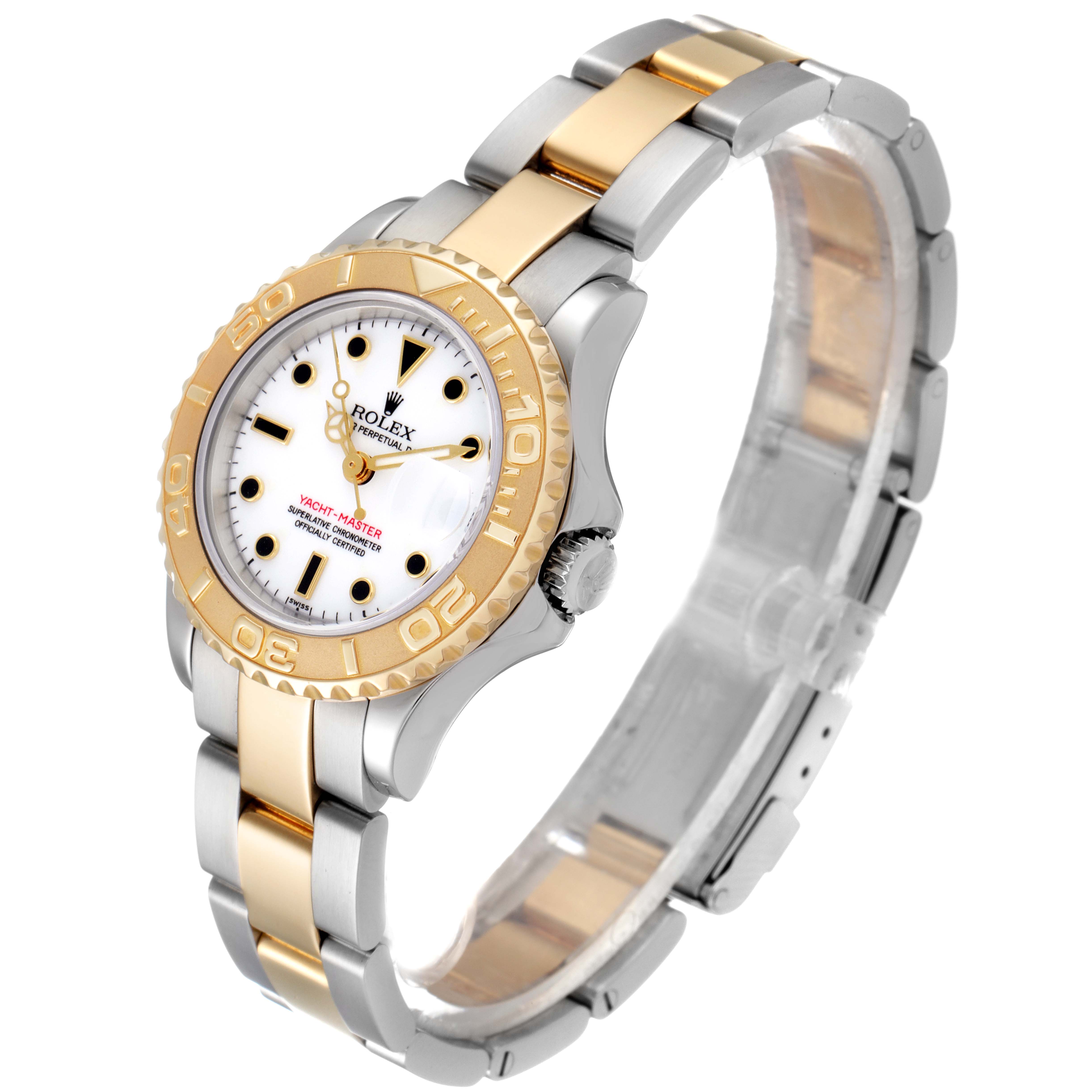The image shows a Rolex Yacht-Master 69623 Women's Steel and Gold (two tone) White Dial 69623 Women's Steel and Gold (two tone) White Dial watch at an angle highlighting the case, bezel, dial, bracelet, and clasp.