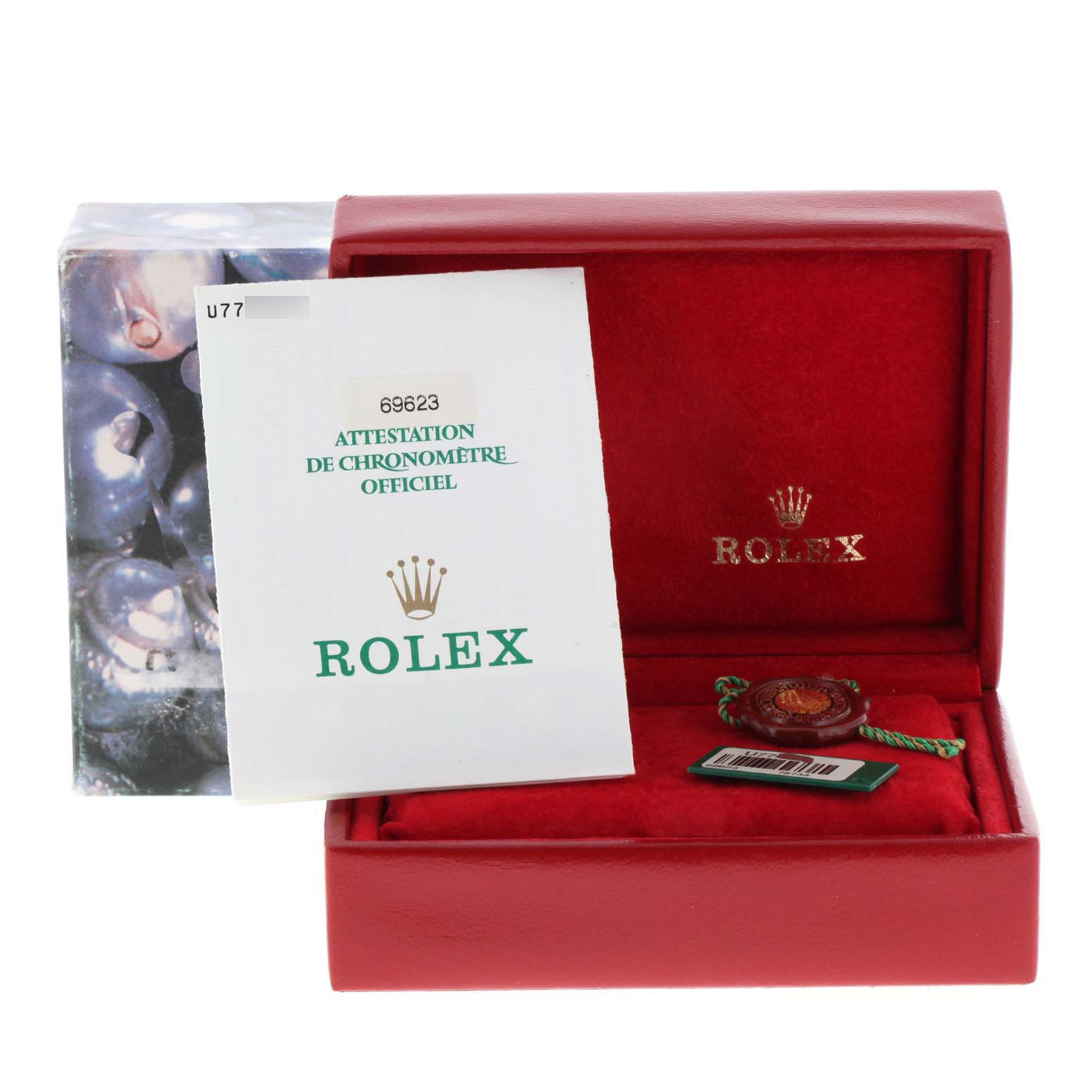 The image shows the packaging, certificate, and accessory tag of a Rolex Yacht-Master 69623 Women's Steel and Gold (two tone) White Dial 69623 Women's Steel and Gold (two tone) White Dial watch from a front view.