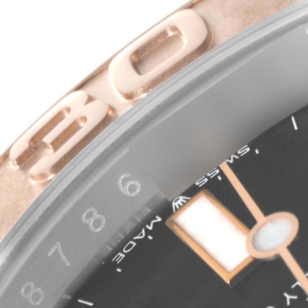 The image shows a close-up of a part of the bezel and dial of a Rolex Yacht-Master 126621 Men
s Steel and Gold (two tone) Black Dial 126621 Men
s Steel and Gold (two tone) Black Dial watch, featuring the 6 on the dial and gold bezel markings.