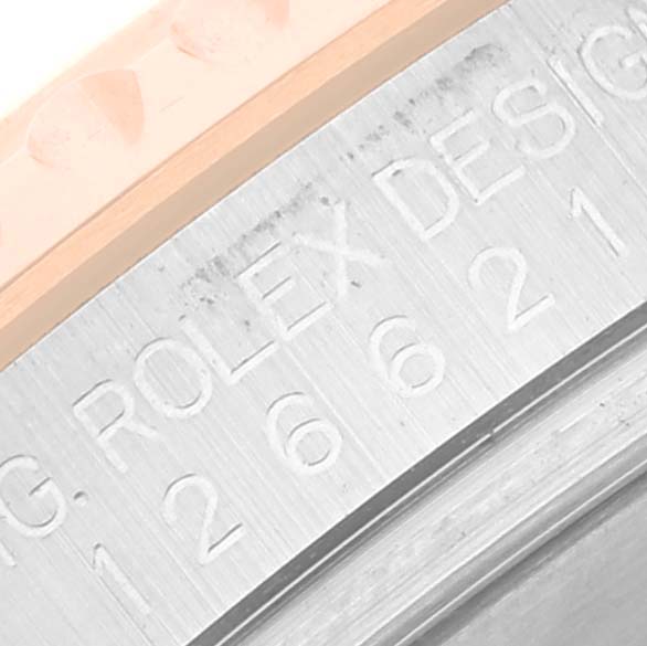 The image shows a close-up of the Rolex Yacht-Master 126621 Men
s Steel and Gold (two tone) Black Dial 126621 Men
s Steel and Gold (two tone) Black Dial watch case, focusing on the engraved "ROLEX DESIGN" text and part of the bezel.