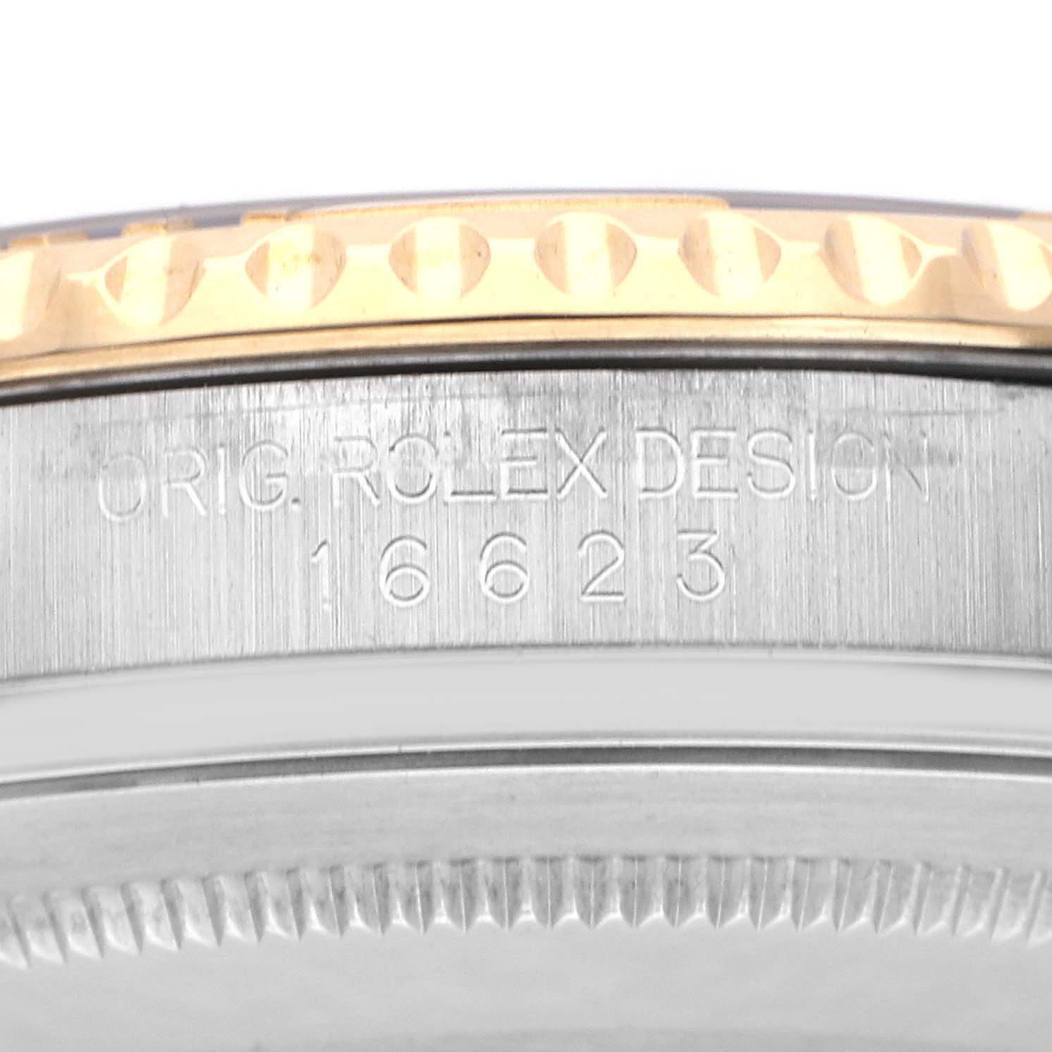 The image shows a side angle of the Rolex Yacht-Master 16623 Men
s Steel and Gold (two tone) White Dial 16623 Men
s Steel and Gold (two tone) White Dial
s bezel and case with model number 16623 engraved.