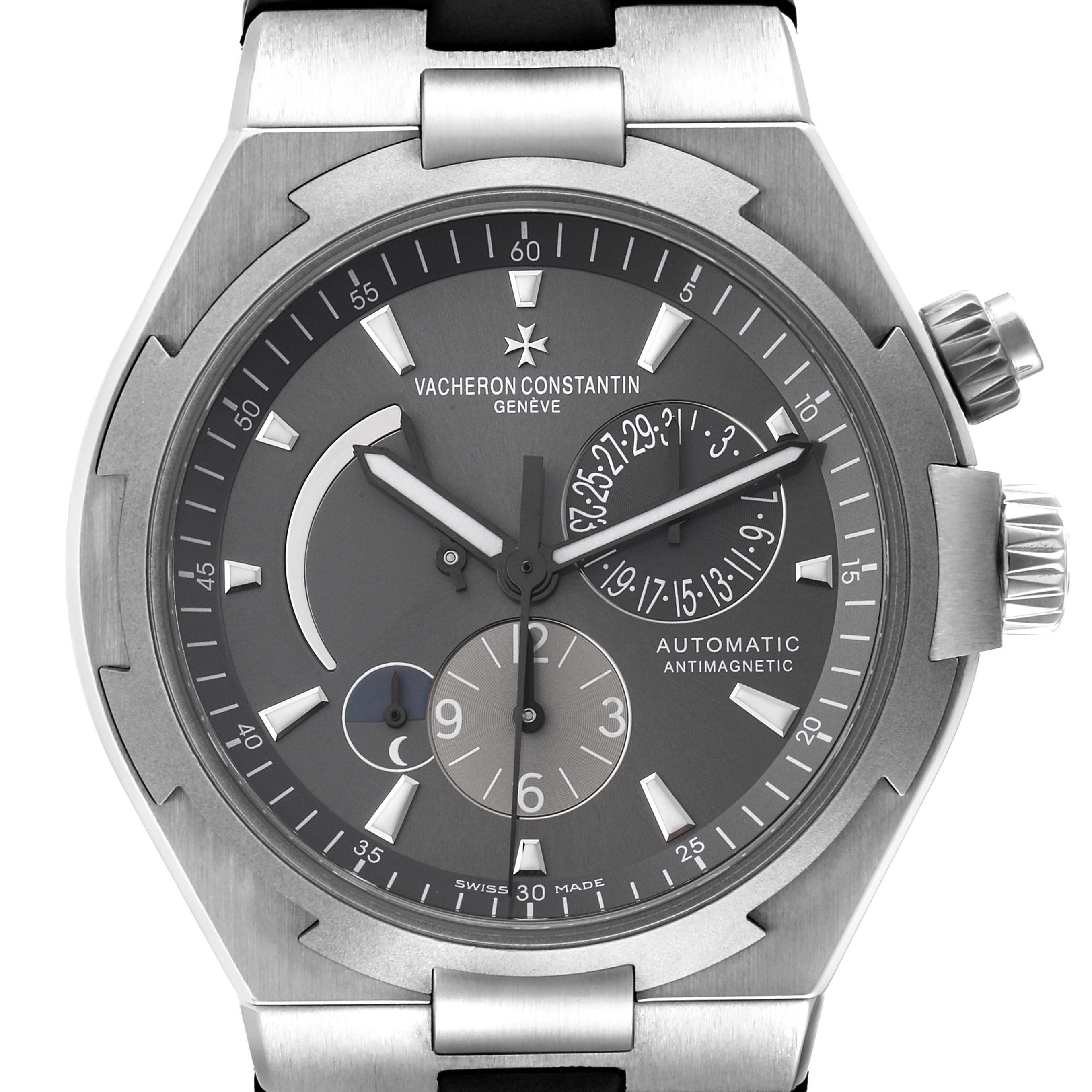 The image shows a Vacheron Constantin Overseas 47450/000W-9511 Men
s Stainless Steel Black Dial 47450/000W-9511 Men
s Stainless Steel Black Dial watch face, highlighting the dial, hands, subdials, and crown from a frontal angle.