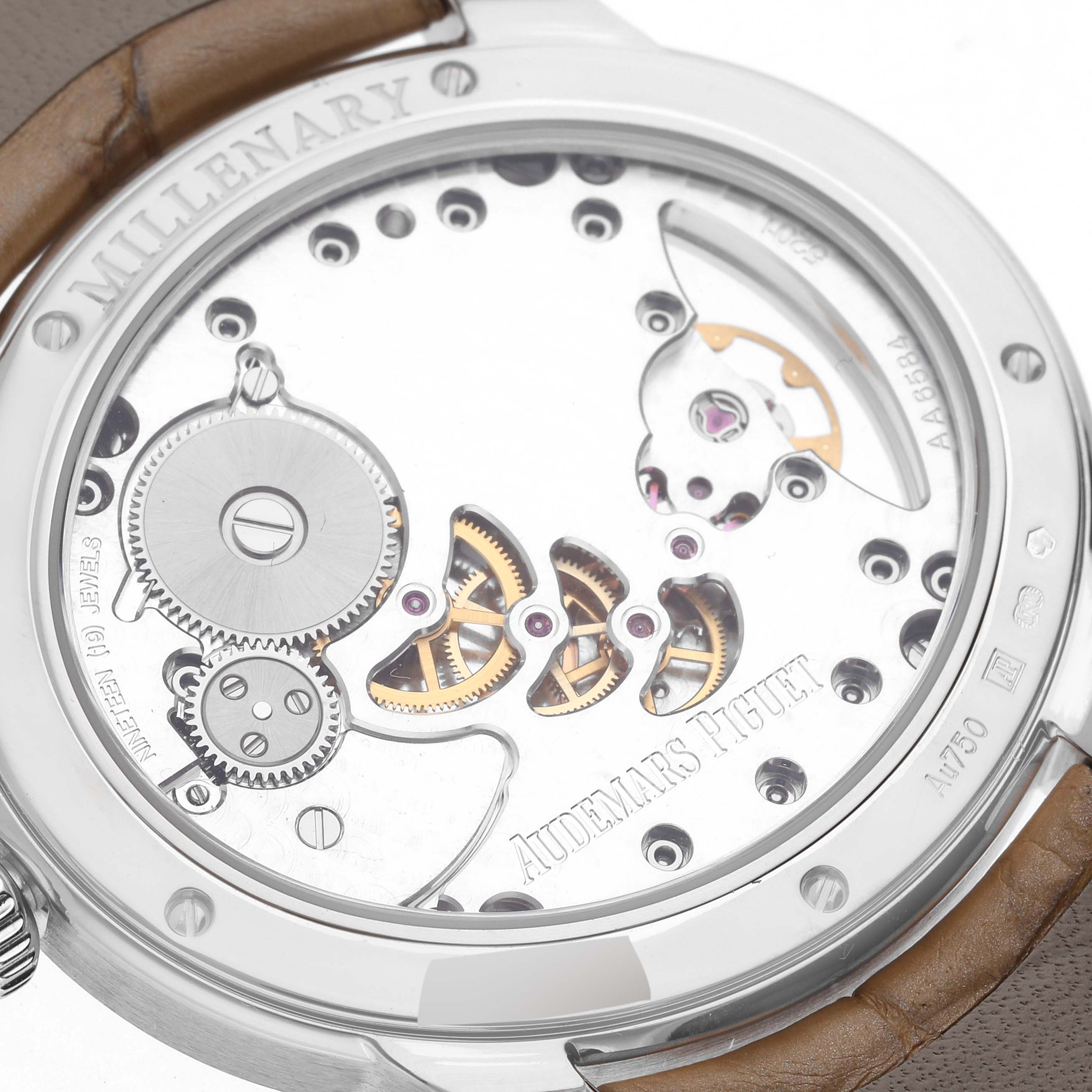 The image shows the back view of an Audemars Piguet Millenary 77247BC.ZZ.A813CR.01 Women's White Gold Mother of Pearl Dial 77247BC.ZZ.A813CR.01 Women's White Gold Mother of Pearl Dial watch, highlighting its intricate mechanical movement.