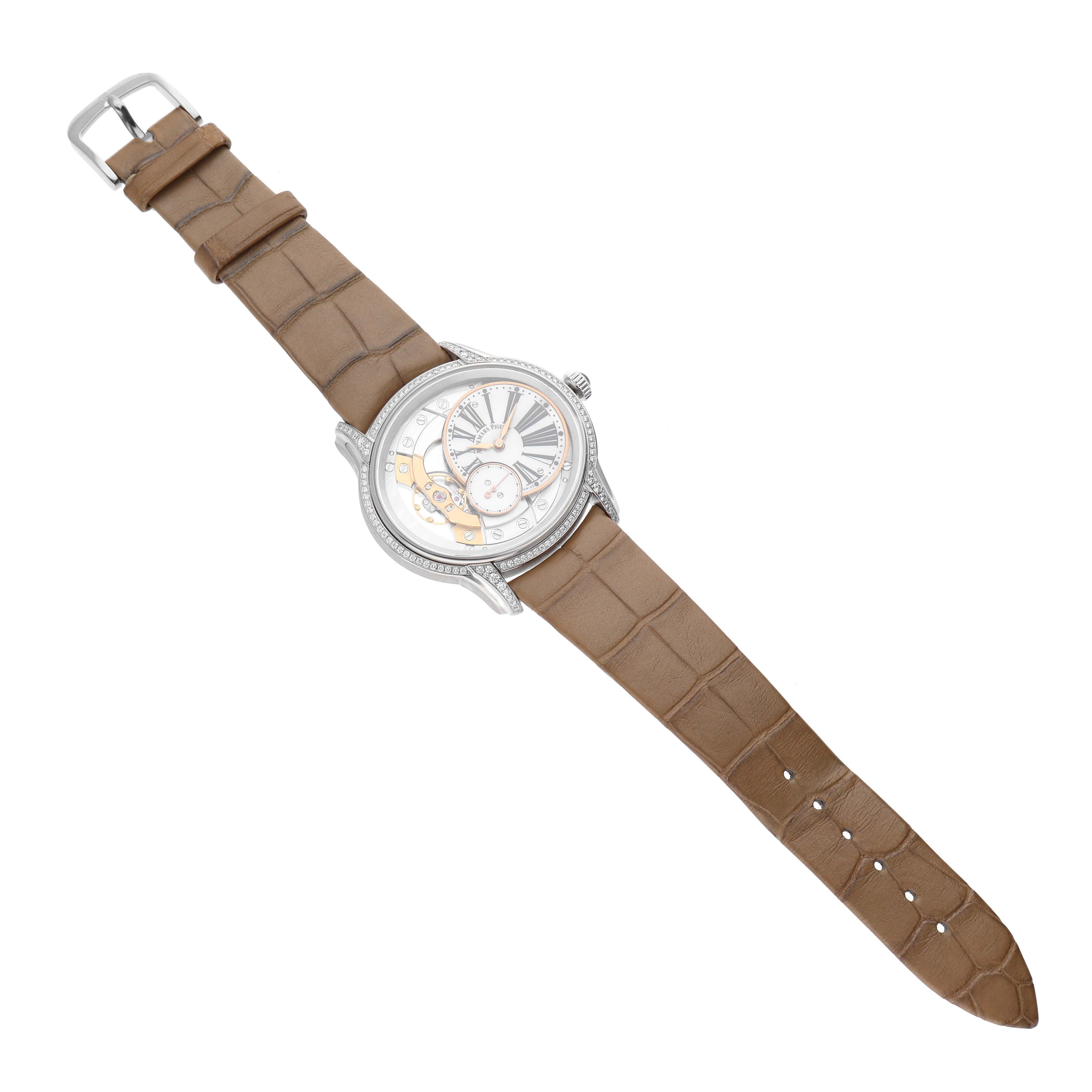 The Audemars Piguet Millenary 77247BC.ZZ.A813CR.01 Women's White Gold Mother of Pearl Dial 77247BC.ZZ.A813CR.01 Women's White Gold Mother of Pearl Dial watch is shown from an overhead angle, showcasing its face and brown leather strap.