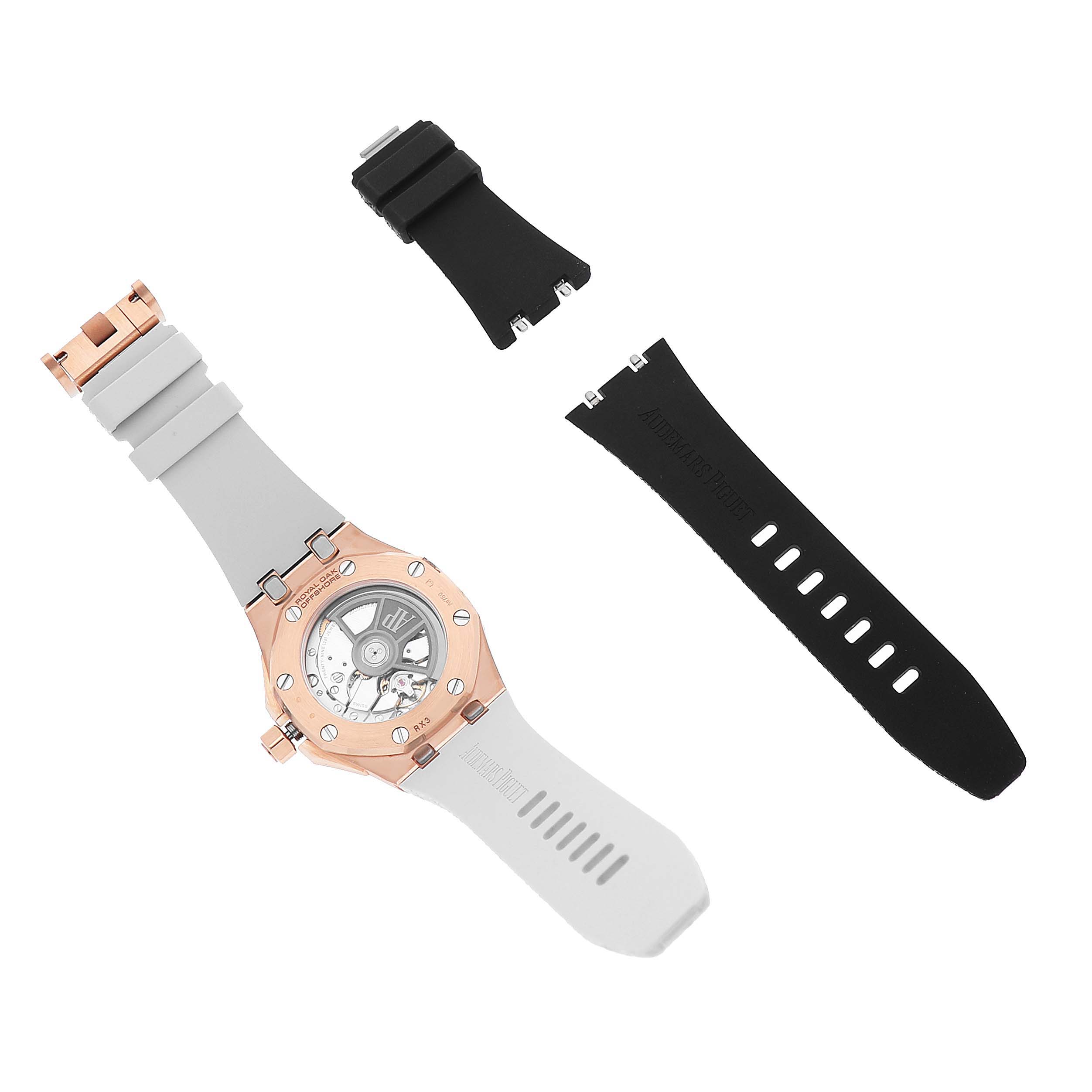 The Audemars Piguet Royal Oak Offshore 77605OK Mens Rose Gold White Dial is shown from the back, with the case, a white strap, and two black strap segments displayed.