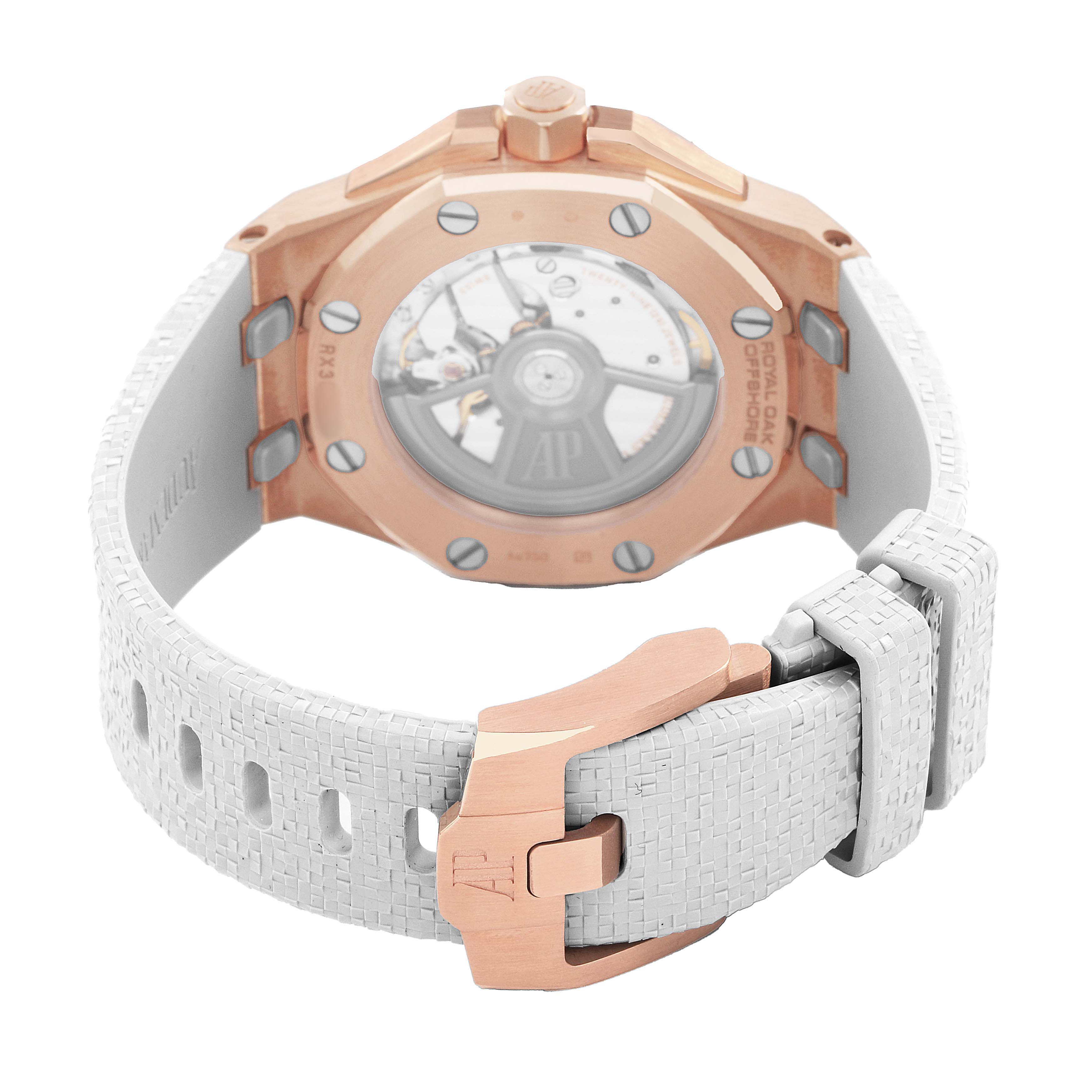 The image shows the back of the Audemars Piguet Royal Oak Offshore 77605OK Mens Rose Gold White Dial, highlighting the rose gold case, white strap, and deployment clasp.