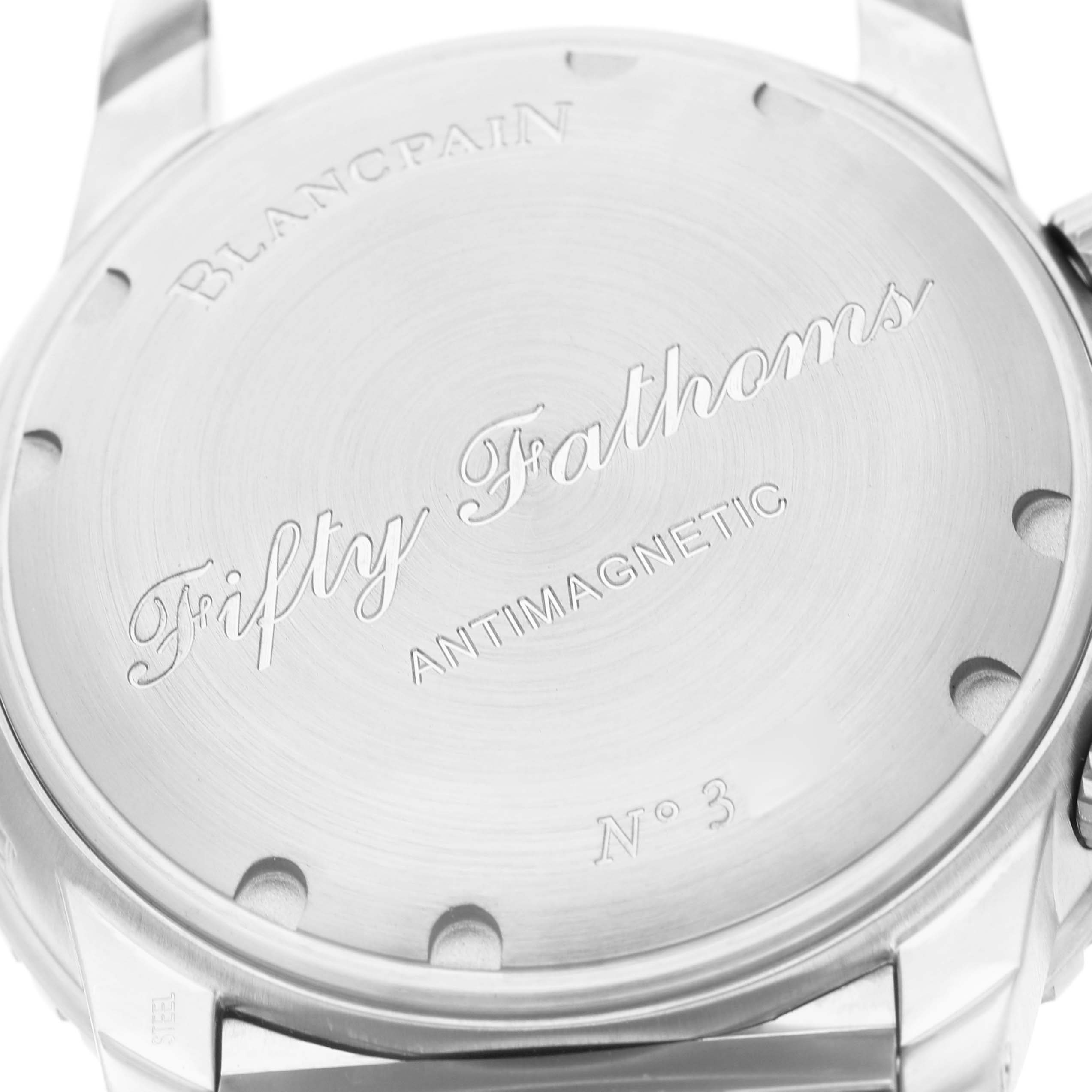 The image shows the case back of the Blancpain Fifty Fathoms 5085FB-1140-71B Men's Stainless Steel Blue Dial watch, highlighting the engraved text and screws.