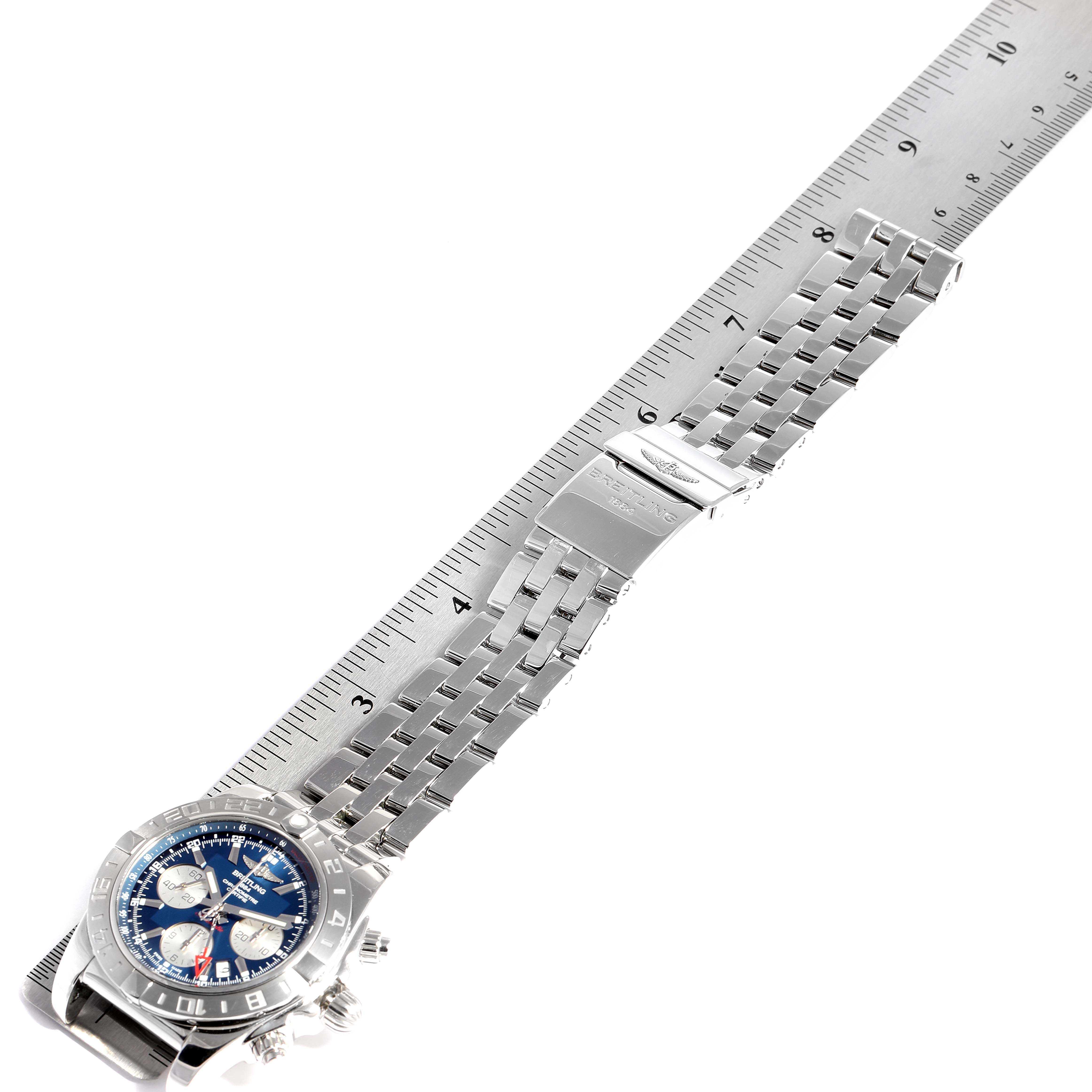 The image shows a Breitling Chronomat AB042011/C851-375A Men
s Stainless Steel Blue Dial AB042011/C851-375A Men
s Stainless Steel Blue Dial watch with its band fully extended, laid flat against a ruler for measurement.