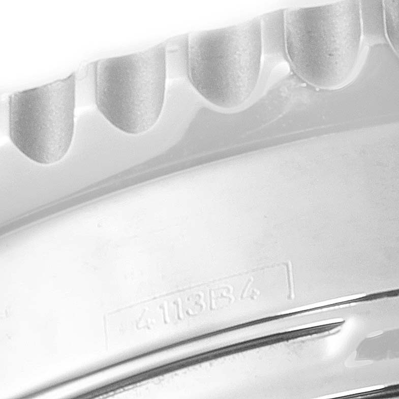 This image shows a close-up of the bezel teeth and part of the engraving on a Breitling Navitimer AB0120 Men
s Stainless Steel Black Dial AB0120 Men
s Stainless Steel Black Dial watch.