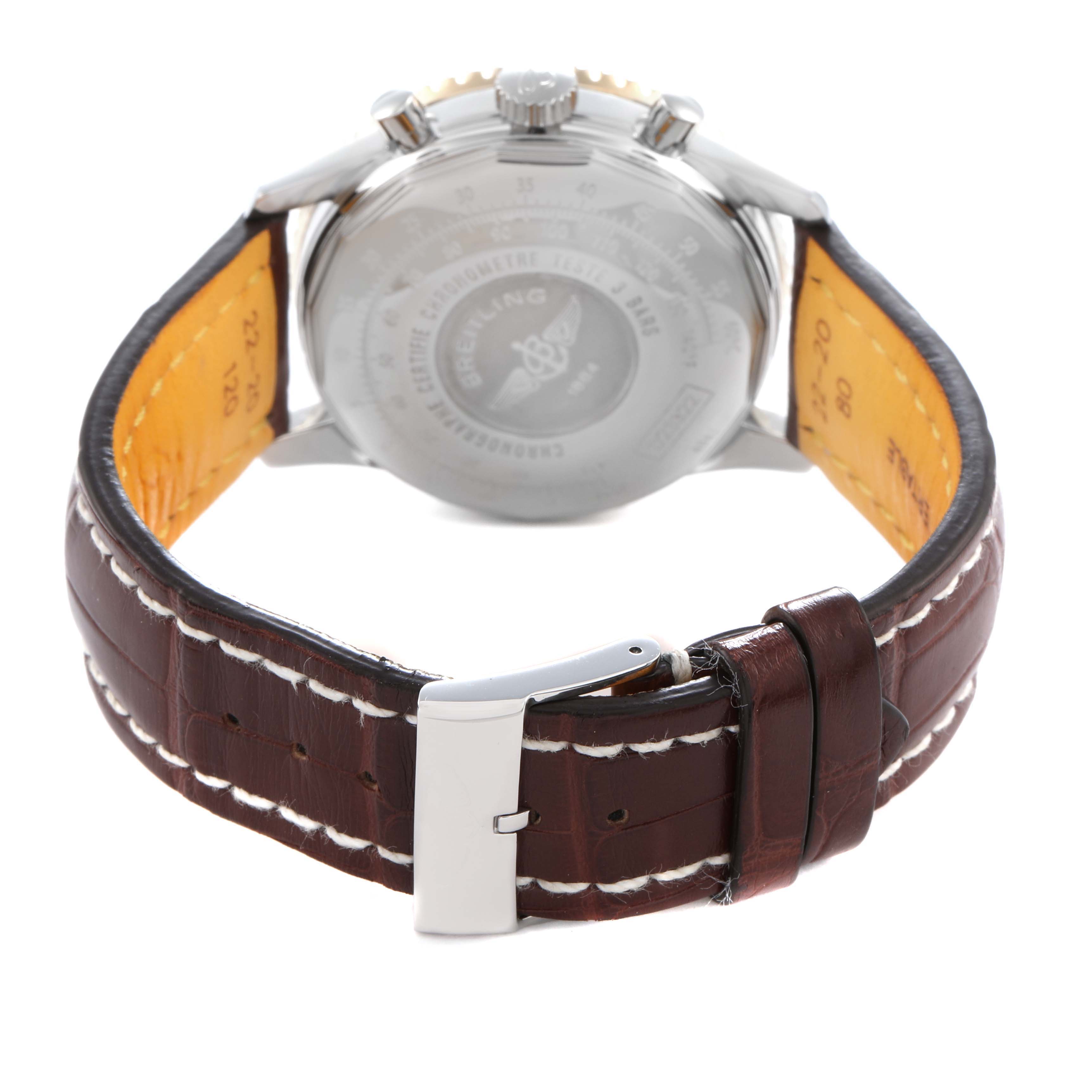 The image shows the back of a Breitling Navitimer D23322 Men
s Steel and Gold (two tone) Black Dial D23322 Men
s Steel and Gold (two tone) Black Dial watch highlighting the caseback, lugs, and brown leather strap with a buckle.