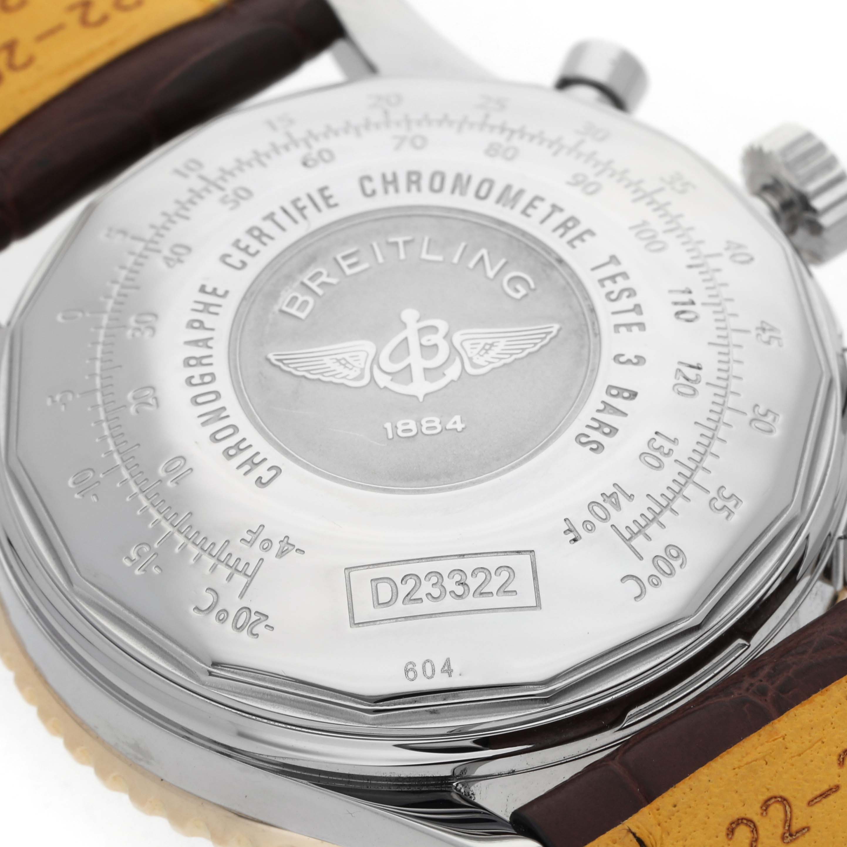 The image shows the back case of the Breitling Navitimer D23322 Men
s Steel and Gold (two tone) Black Dial D23322 Men
s Steel and Gold (two tone) Black Dial watch, detailing its engraved logo and specifications.