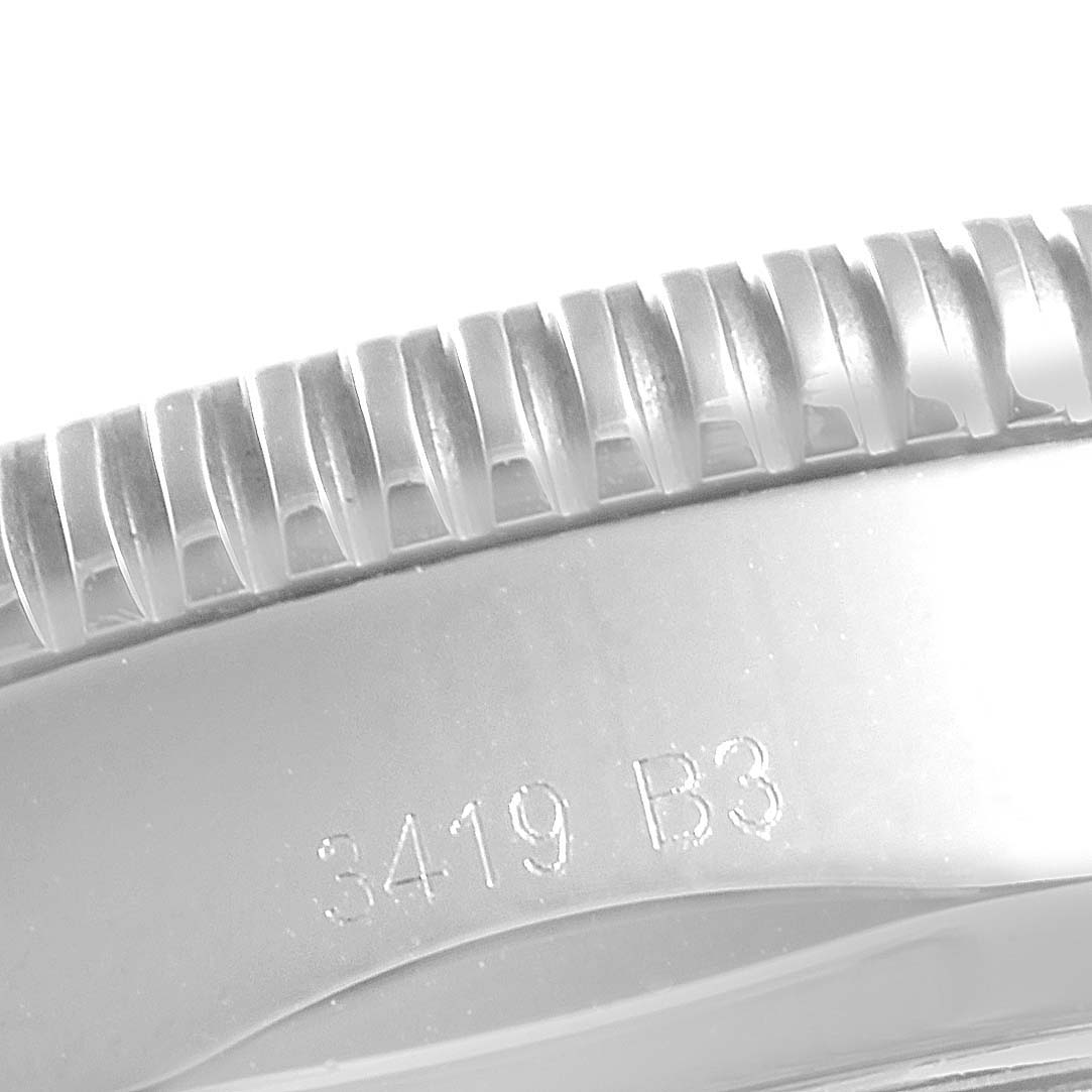 This close-up image shows the textured bezel and a part of the case with an engraved serial number of the Breitling Superocean AB202016-C961-152A Men
s Stainless Steel Blue Dial AB202016-C961-152A Men
s Stainless Steel Blue Dial watch.