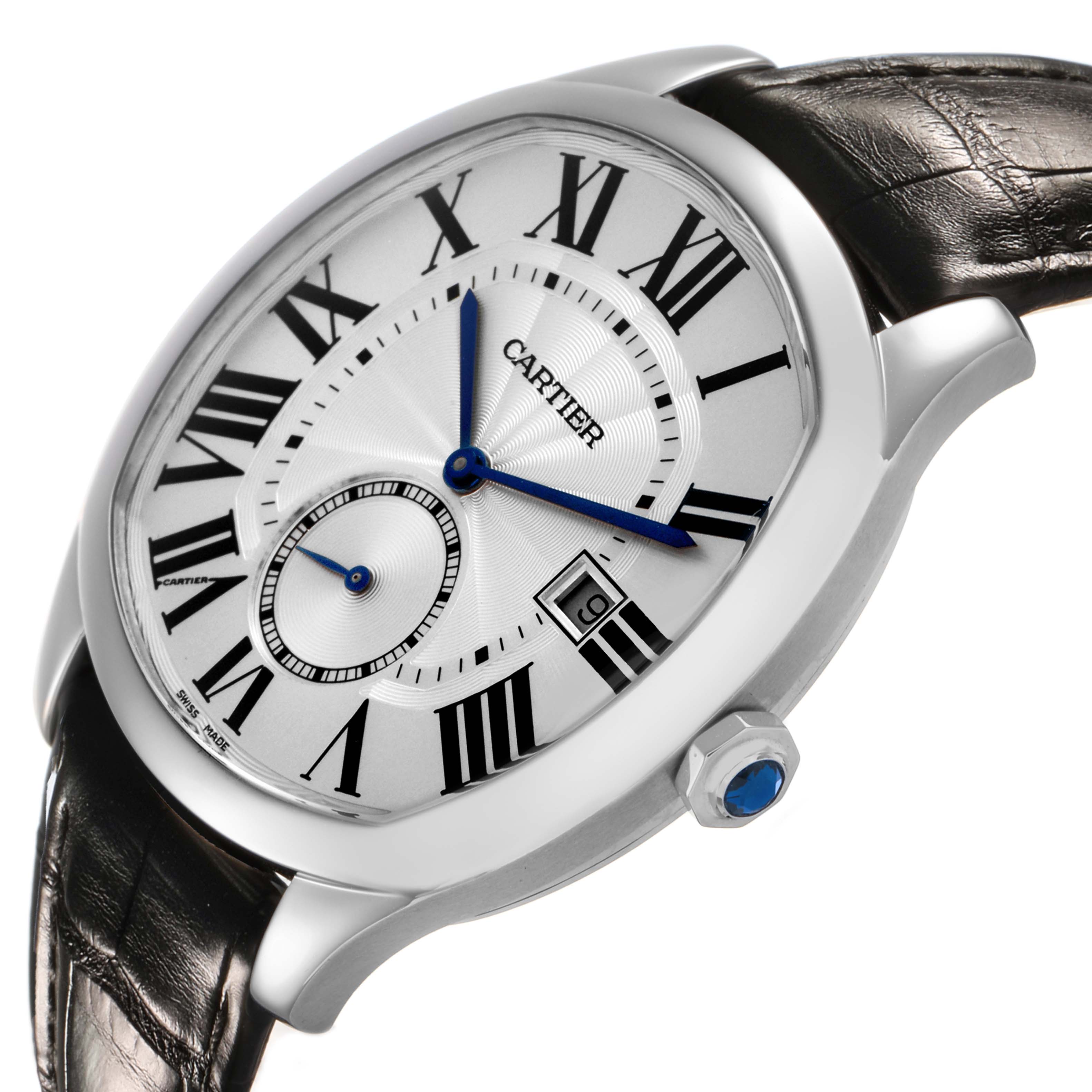 The Drive de Cartier watch is shown at a slight angle, displaying the face, blue hands, and crown with a blue gemstone.