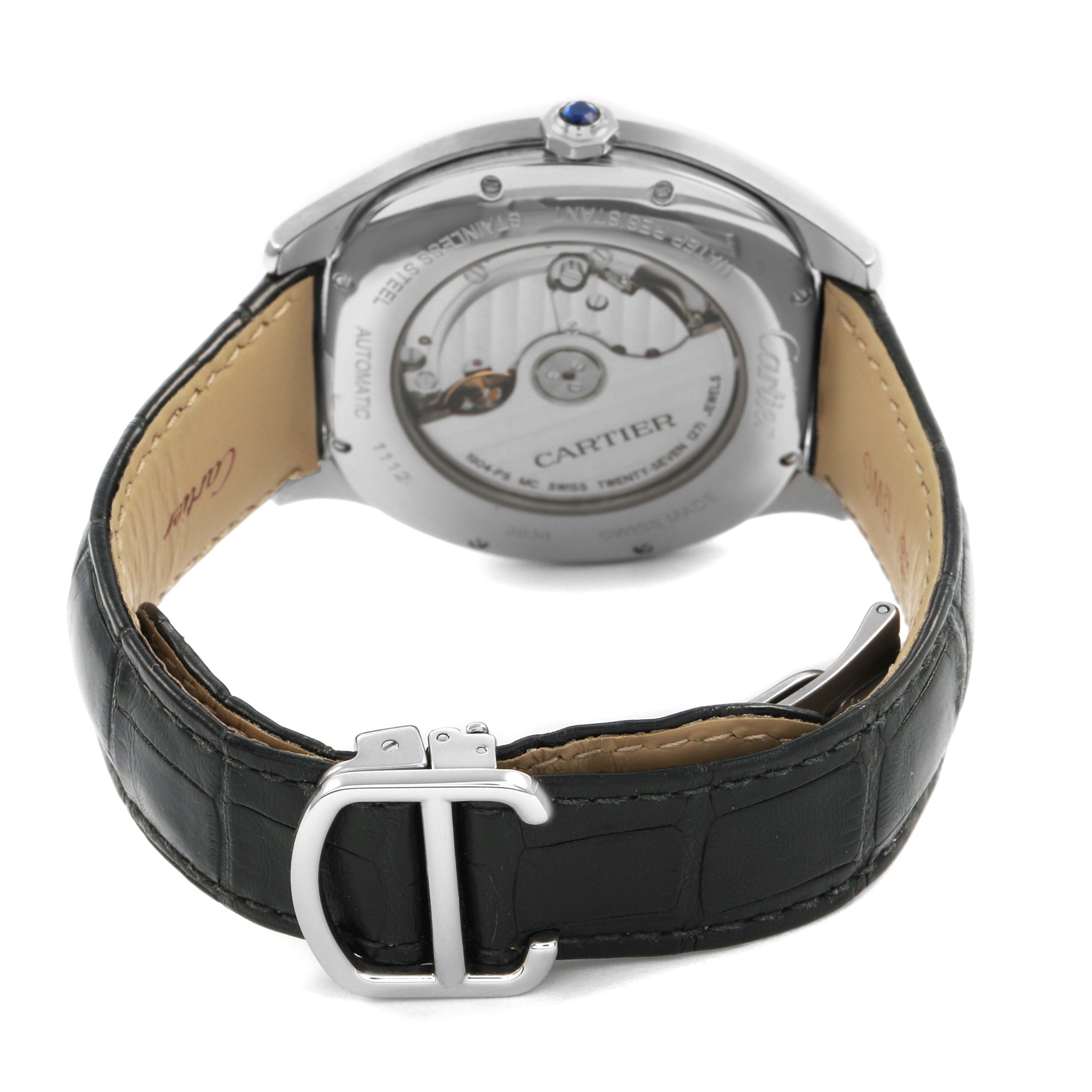 The watch is a Drive de Cartier model, shown from the back, displaying the movement and strap, featuring a blue cabochon on the crown.