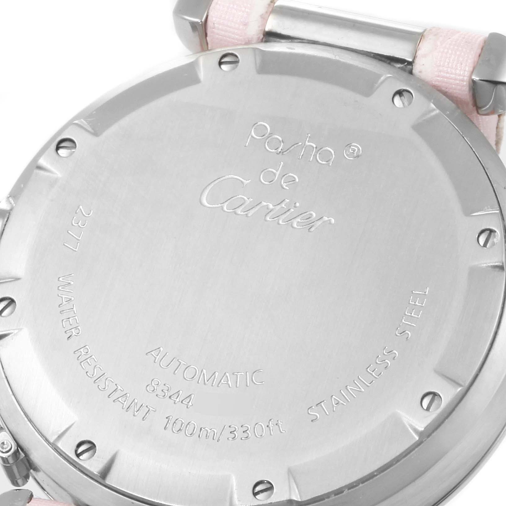 This is a close-up view of the rear caseback of a Cartier Pasha W3107099 Women's Stainless Steel Mother of Pearl Dial W3107099 Women's Stainless Steel Mother of Pearl Dial watch, showing its inscriptions and part of the strap.