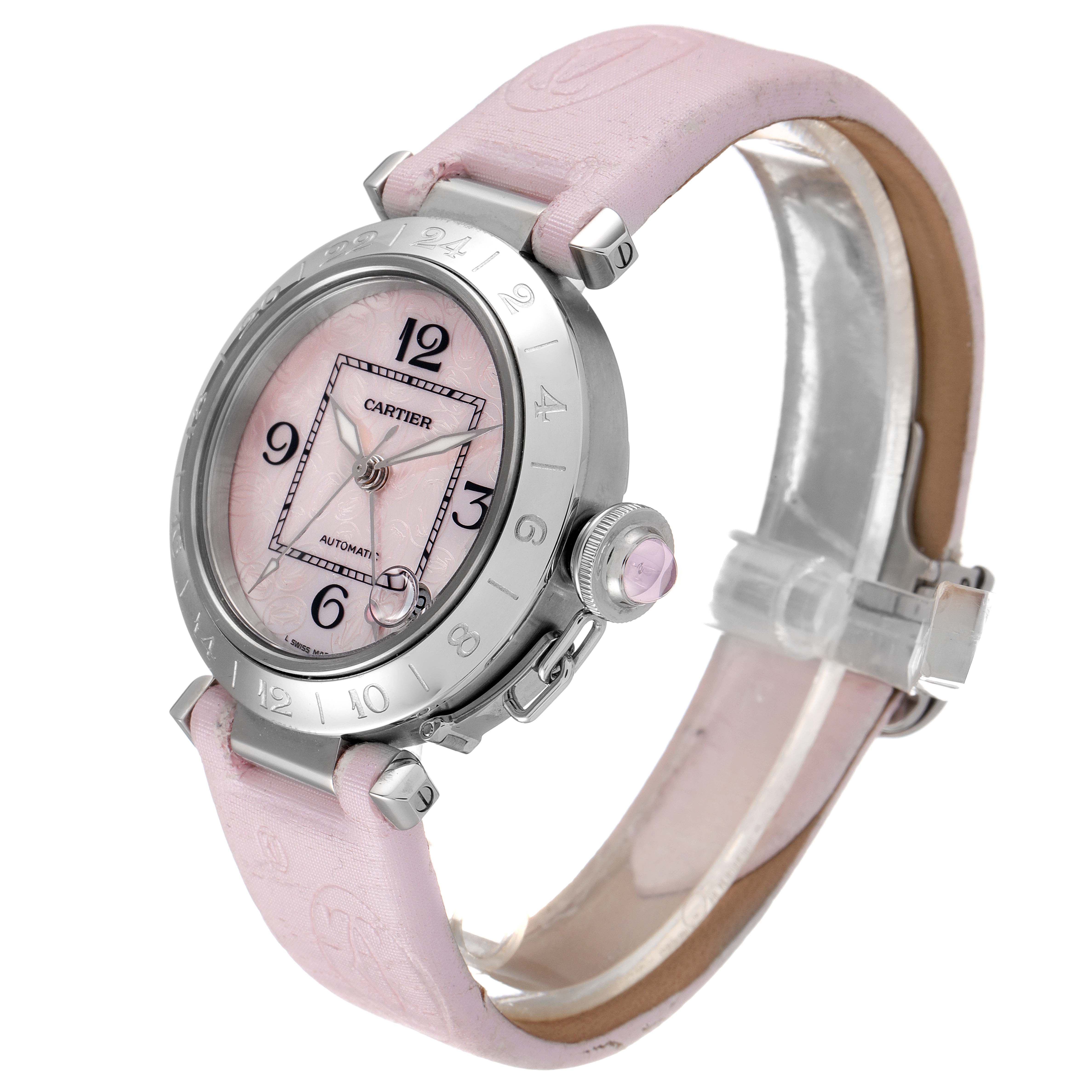 The Cartier Pasha W3107099 Women's Stainless Steel Mother of Pearl Dial W3107099 Women's Stainless Steel Mother of Pearl Dial watch is shown at an angle highlighting its pink dial, bezel, crown, and leather strap.