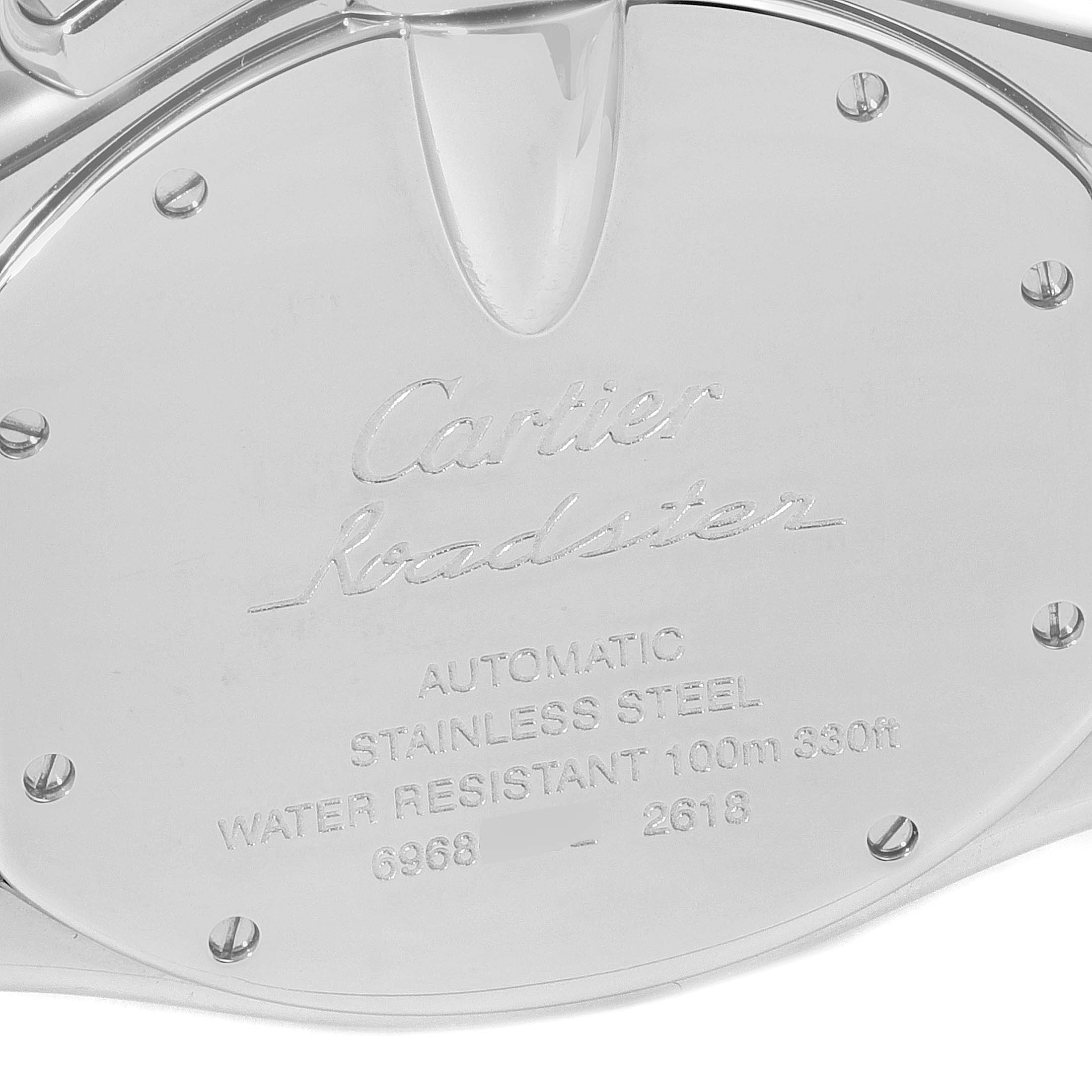 The image shows the back case of a Cartier Roadster W62020X6 Men
s Stainless Steel Black Dial W62020X6 Men
s Stainless Steel Black Dial watch, featuring engraved details and screws.