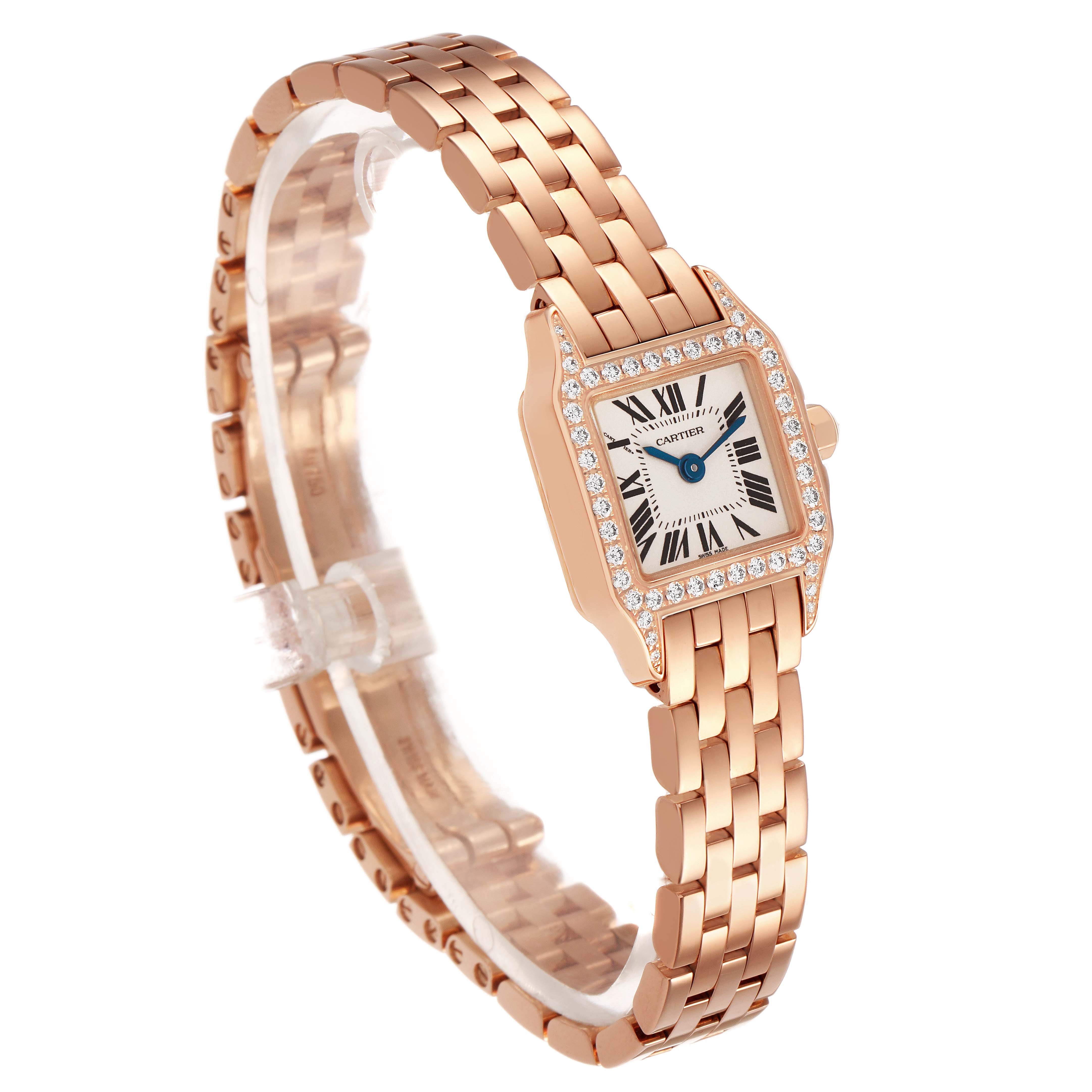 The Cartier Santos Demoiselle WF9011Z8 Women's Rose Gold Silver Dial watch is shown from a three-quarter angle, highlighting its rose gold bracelet, diamond-set bezel, and Roman numeral dial.