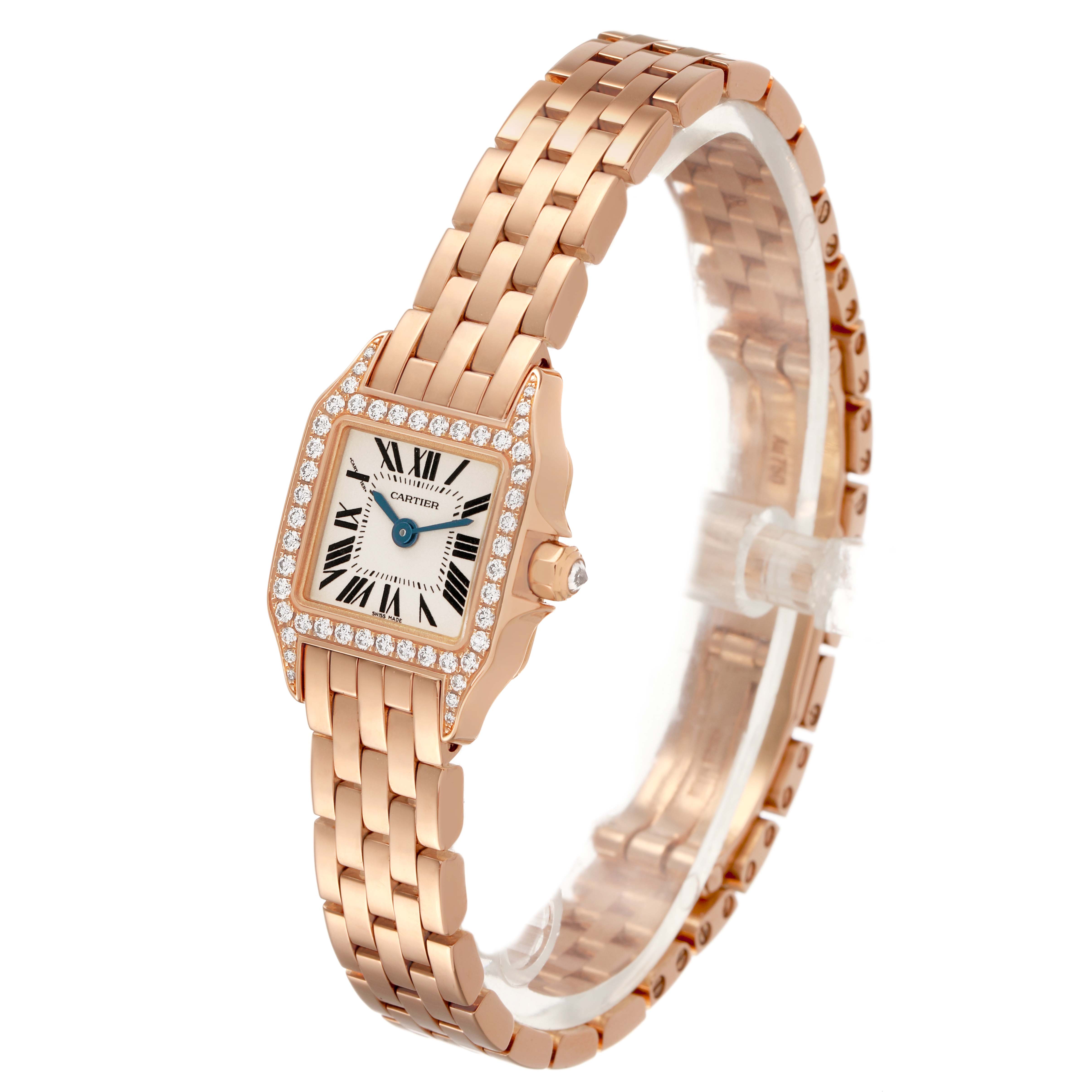 The Cartier Santos Demoiselle WF9011Z8 Women's Rose Gold Silver Dial watch is shown at a three-quarter angle, highlighting its diamond bezel and rose gold bracelet.