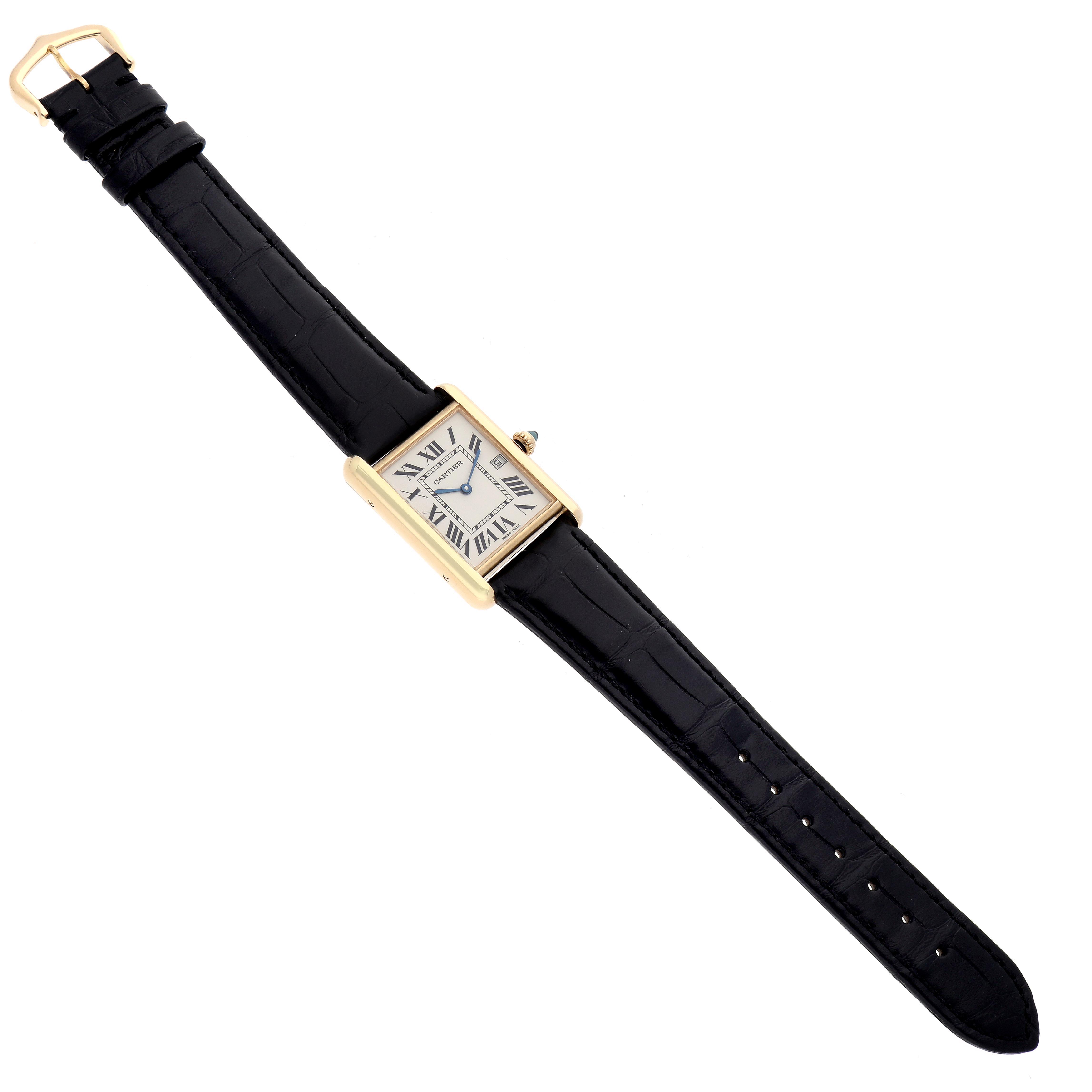 The Cartier Tank Louis W1529756 Men
s Yellow Gold Silver Dial W1529756 Men
s Yellow Gold Silver Dial watch is shown from a top-down angle, featuring its rectangular case, roman numeral dial, and black strap.