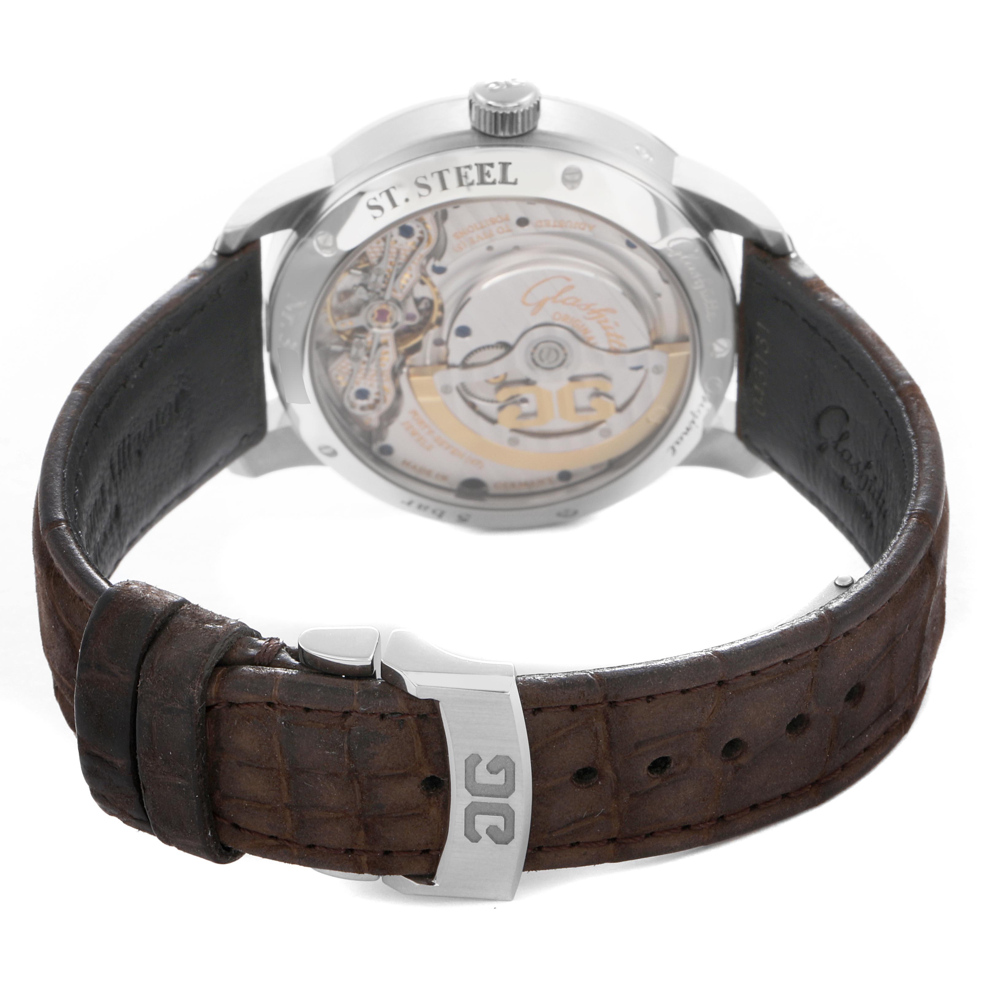 The image shows the back view of a Glashütte Pano watch, highlighting the movement and detailing on the leather strap and buckle.