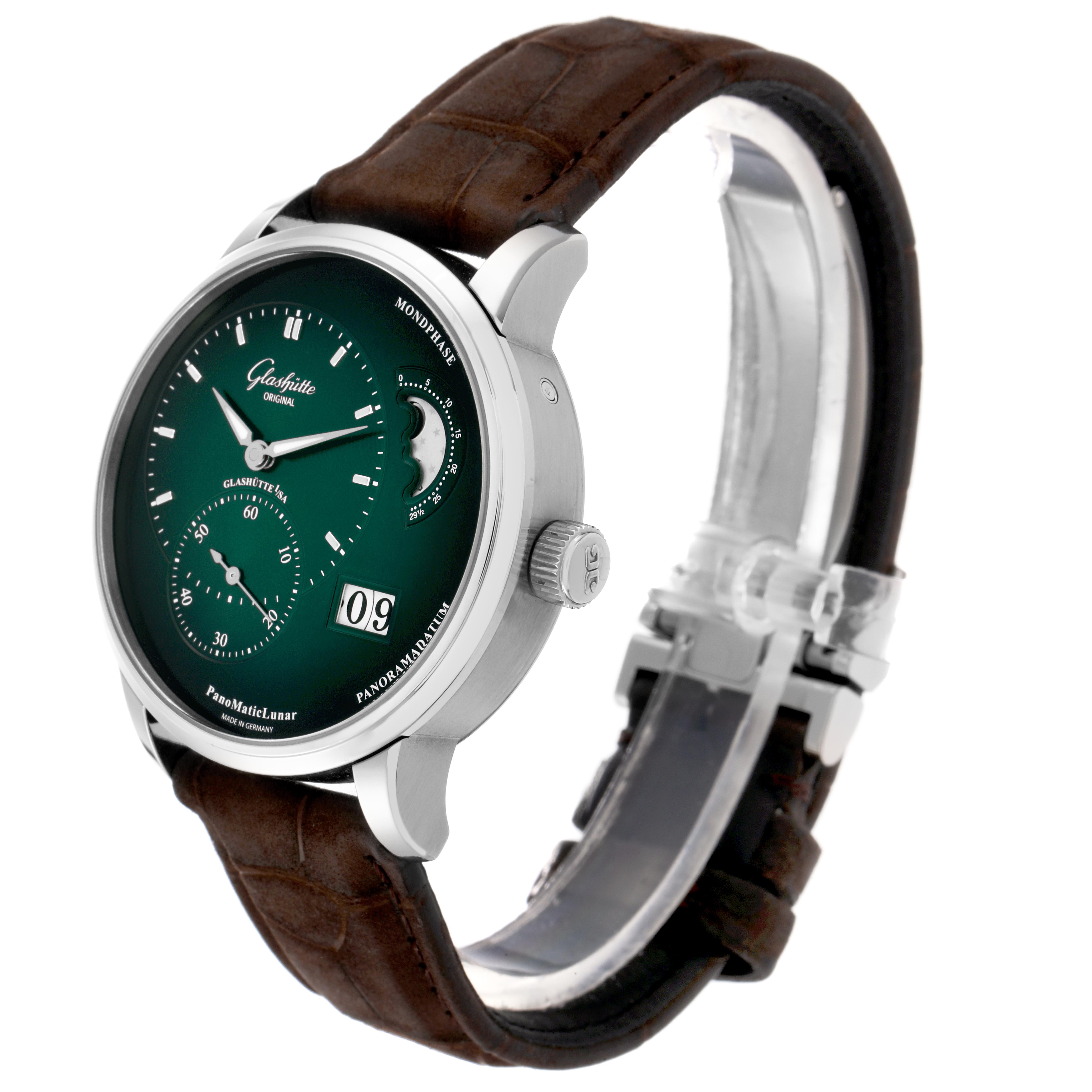 The Glashütte Pano watch is shown at a front angle, displaying its dial, moon phase, crown, and leather strap.