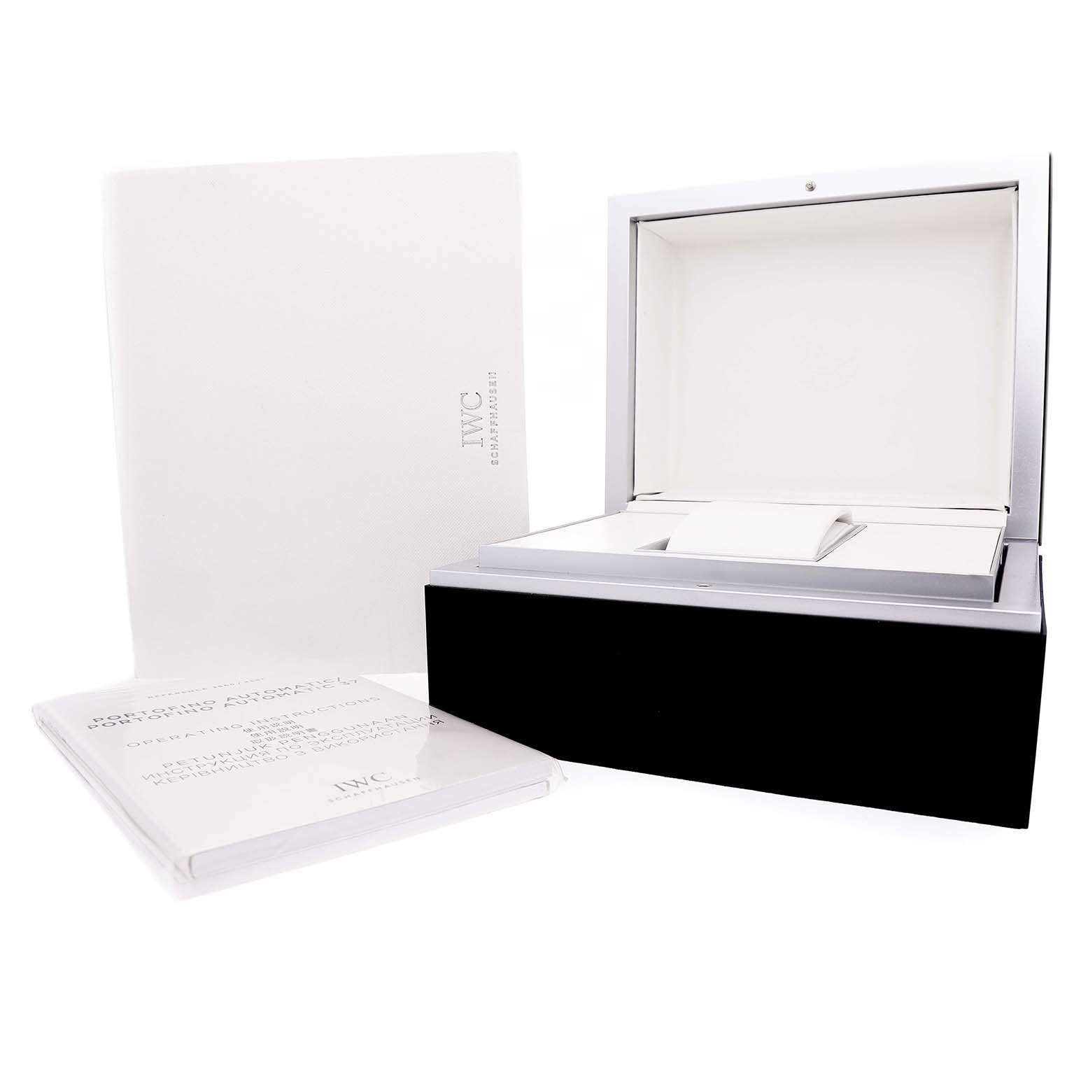 The image shows an open IWC Portofino IW371604 Men's Stainless Steel Silver Dial watch box with a booklet, viewed from a front angle.