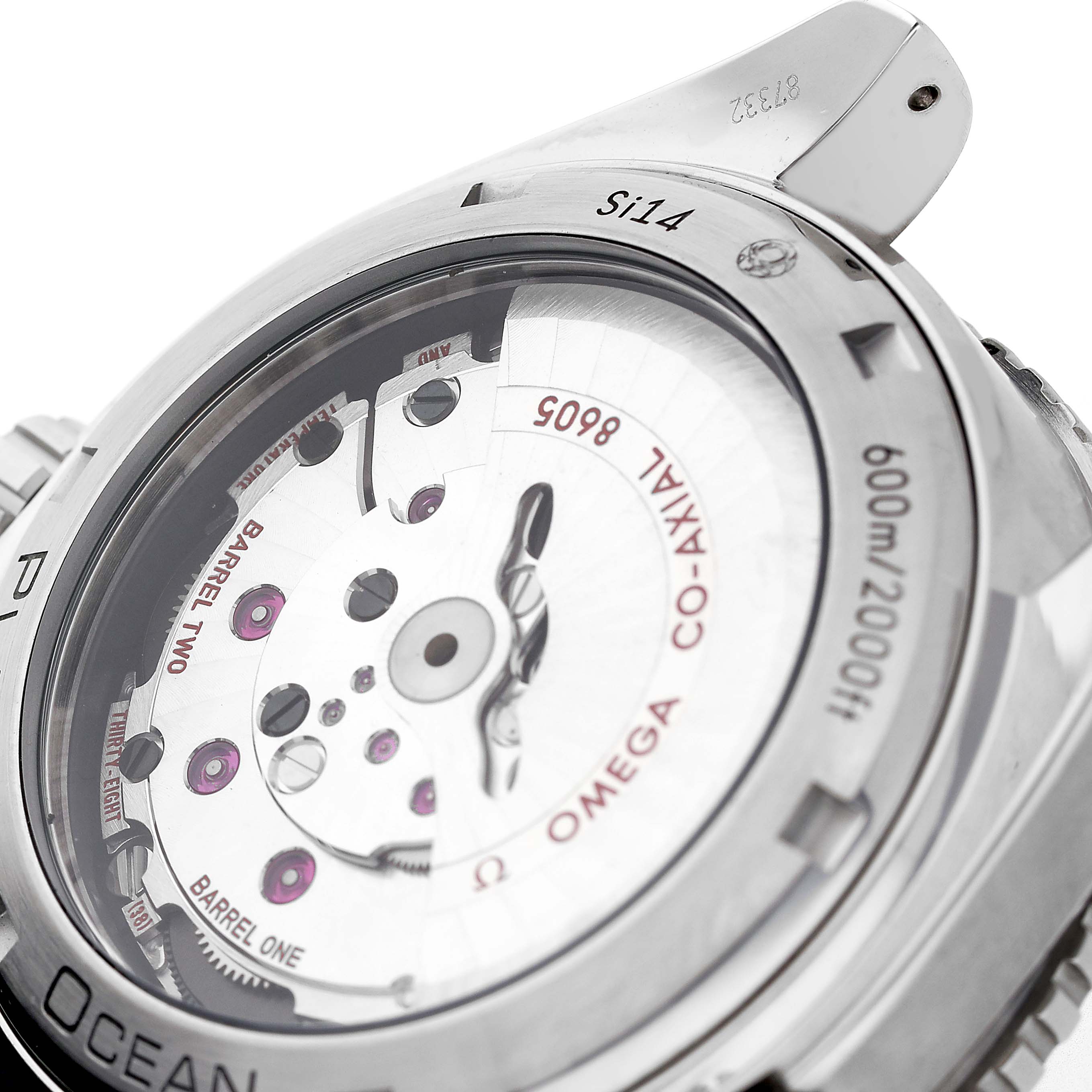 The image shows the case back of the Omega Planet Ocean 232.32.44.22.01.001 Mens Stainless Steel Black Dial, highlighting its mechanical movement and Co-Axial escapement.
