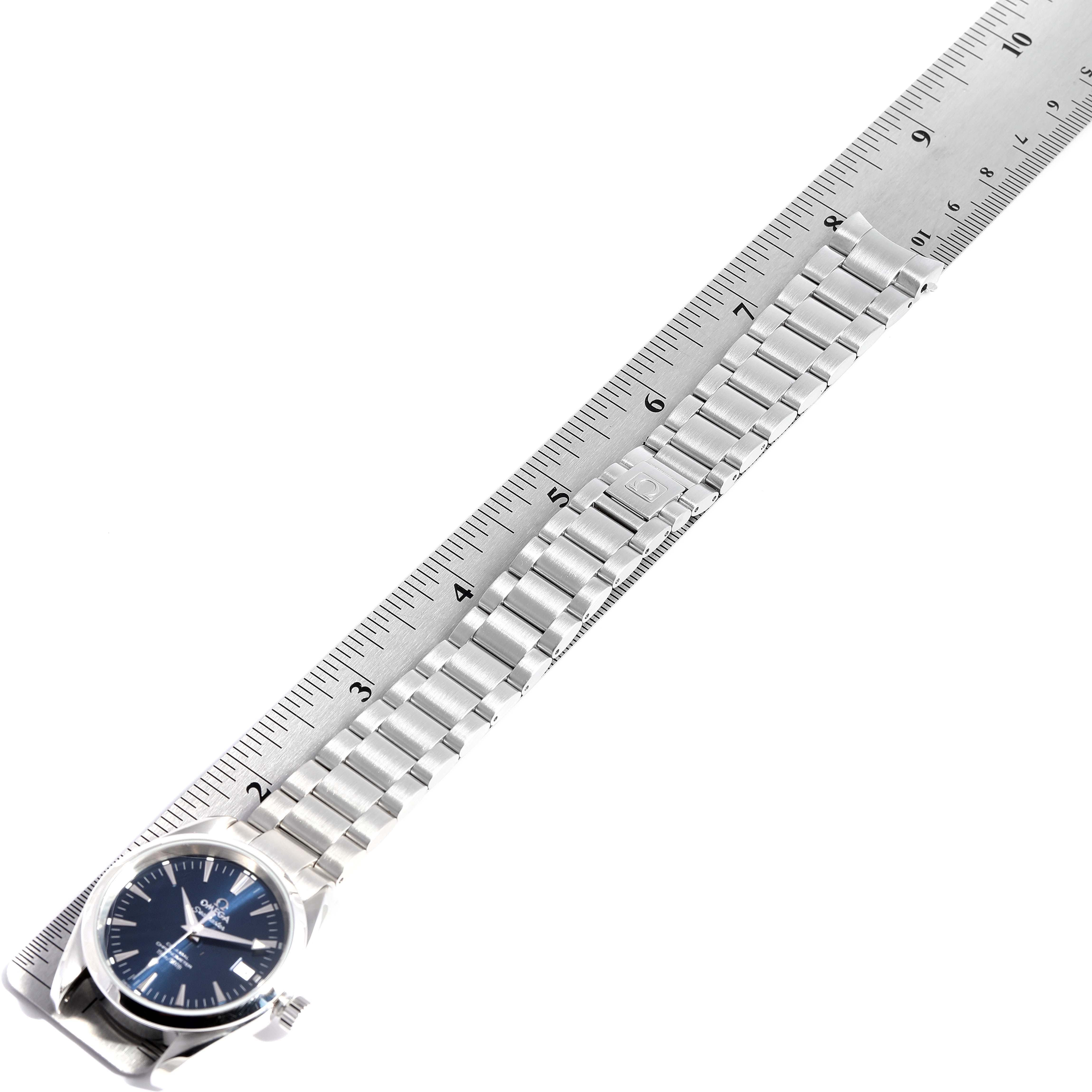 The image shows the Omega Aqua Terra 2504.80.00 Men
s Stainless Steel Blue Dial 2504.80.00 Men
s Stainless Steel Blue Dial watch laid flat, with a metal bracelet measured against a ruler.