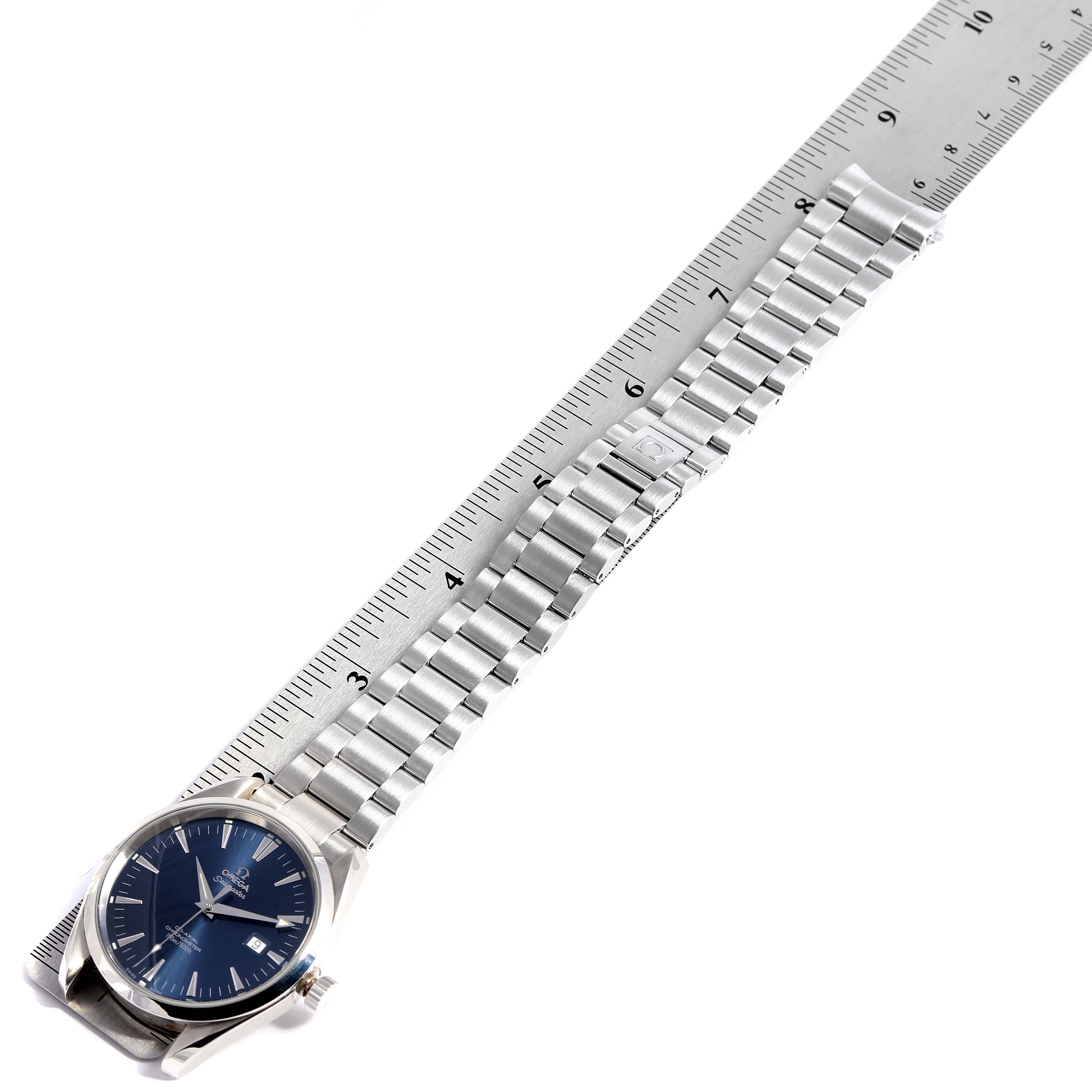 The image shows an Omega Aqua Terra 2502.30.00  Men
s Stainless Steel Blue Dial 2502.30.00  Men
s Stainless Steel Blue Dial watch flat with a ruler, displaying the face, bezel, and metal bracelet.