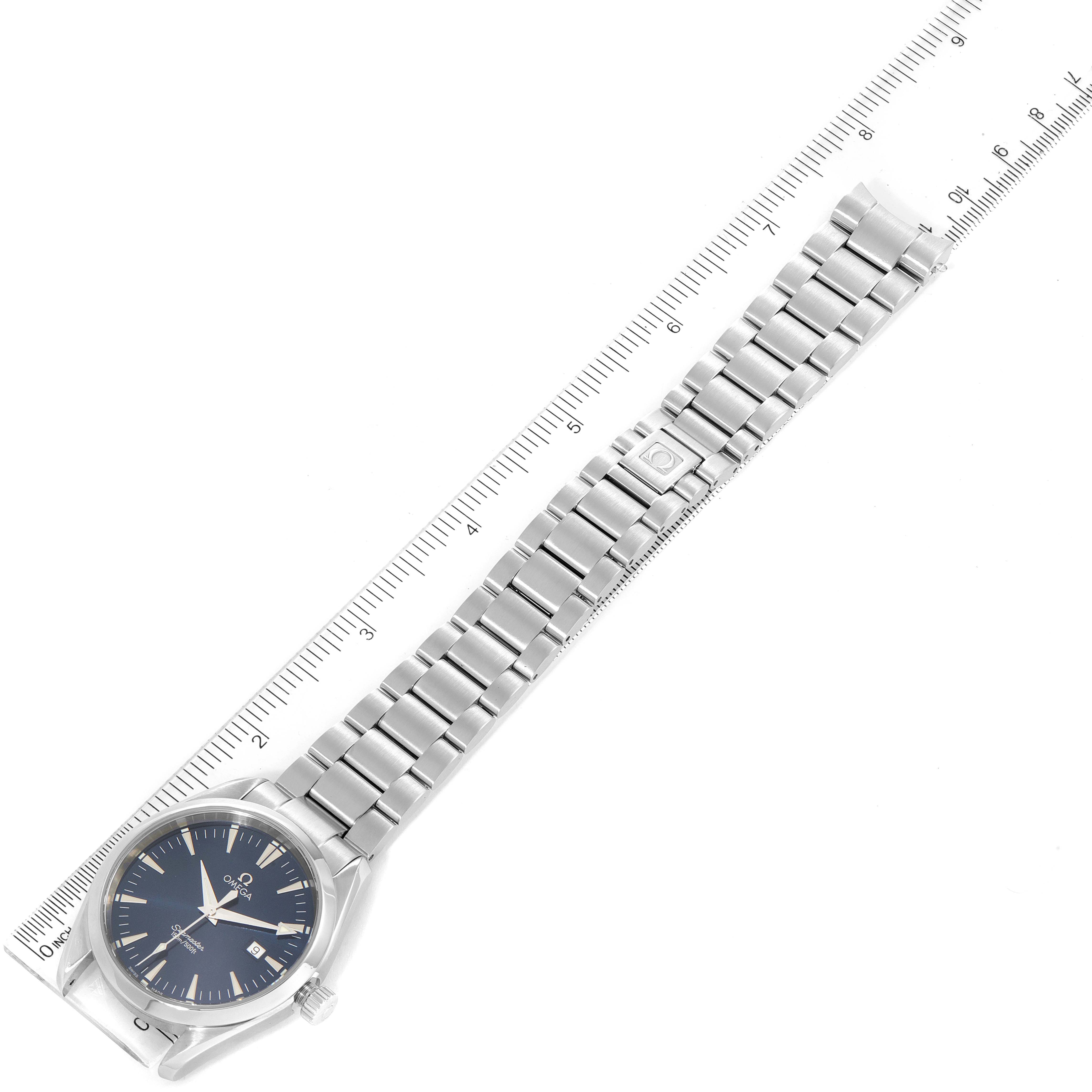 This image shows the entire Omega Aqua Terra 2517.80.00 Men
s Stainless Steel Blue Dial 2517.80.00 Men
s Stainless Steel Blue Dial watch, including its face, bezel, bracelet, and clasp, laid next to a ruler.