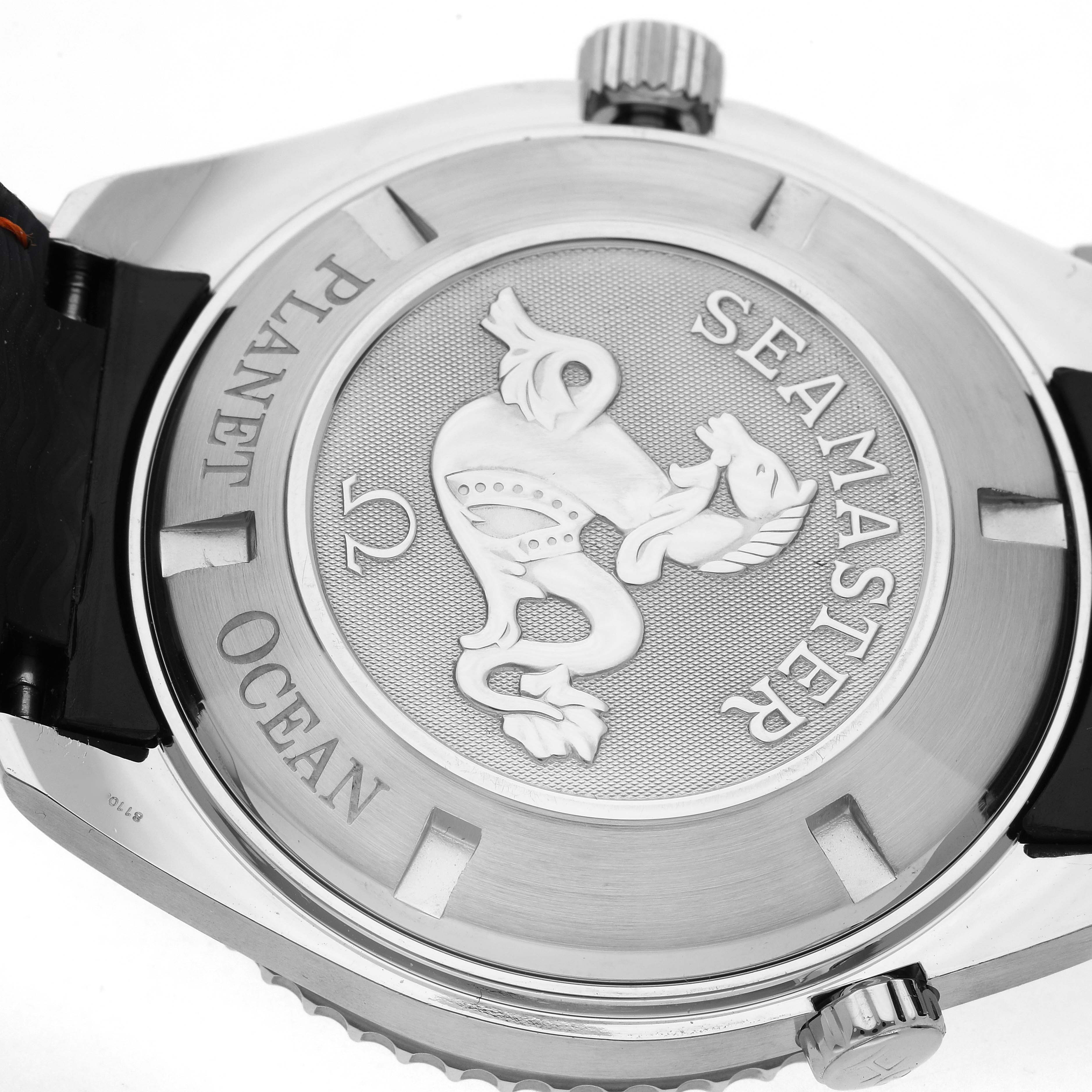 The image shows the back of the Omega Planet Ocean 2908.50.38 Men
s Stainless Steel Black Dial 2908.50.38 Men
s Stainless Steel Black Dial watch, featuring engraved branding and a detailed seahorse emblem.