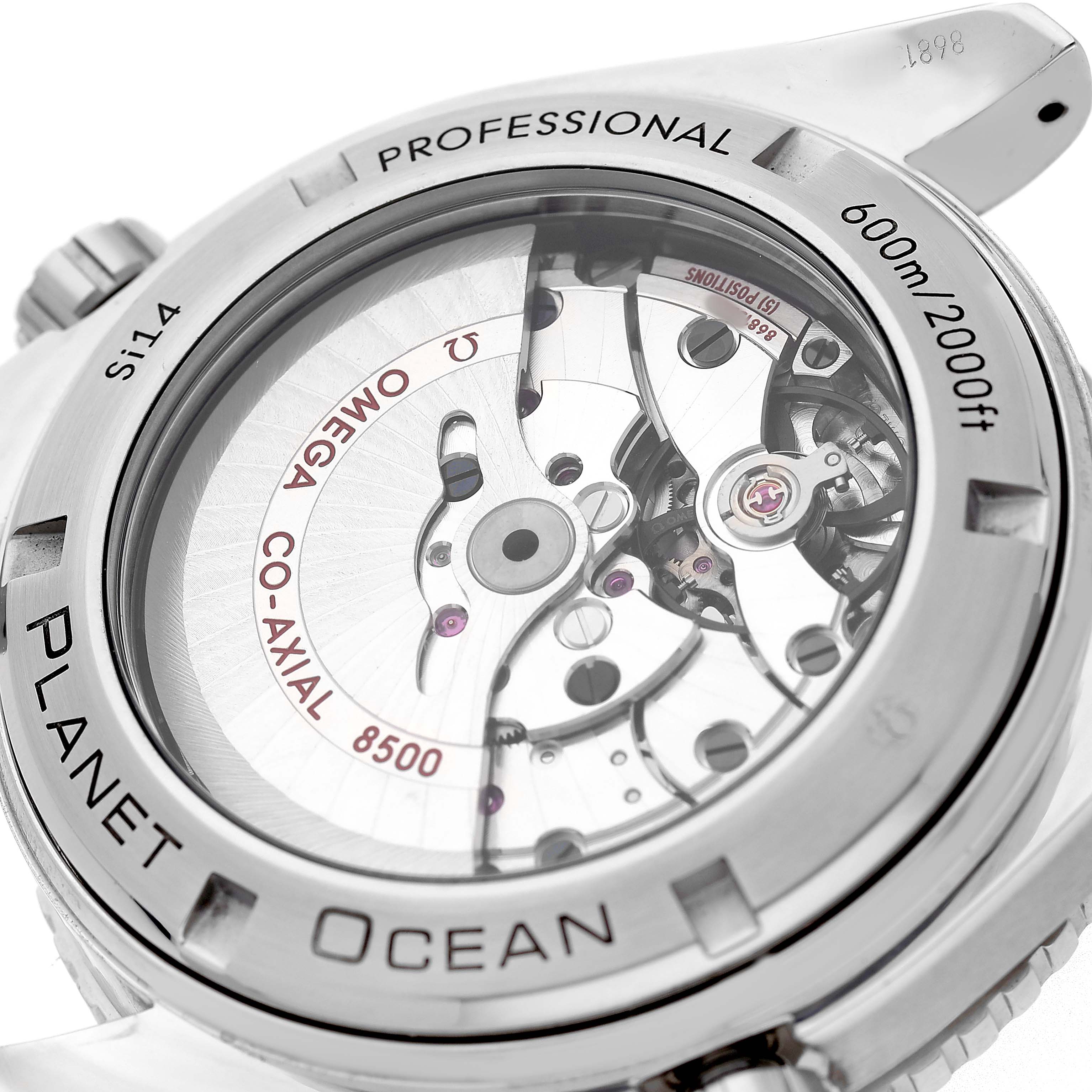 The image shows the back of the Omega Planet Ocean 232.30.46.21.01.001 Men's Stainless Steel Black Dial watch, highlighting the movement and co-axial mechanism.