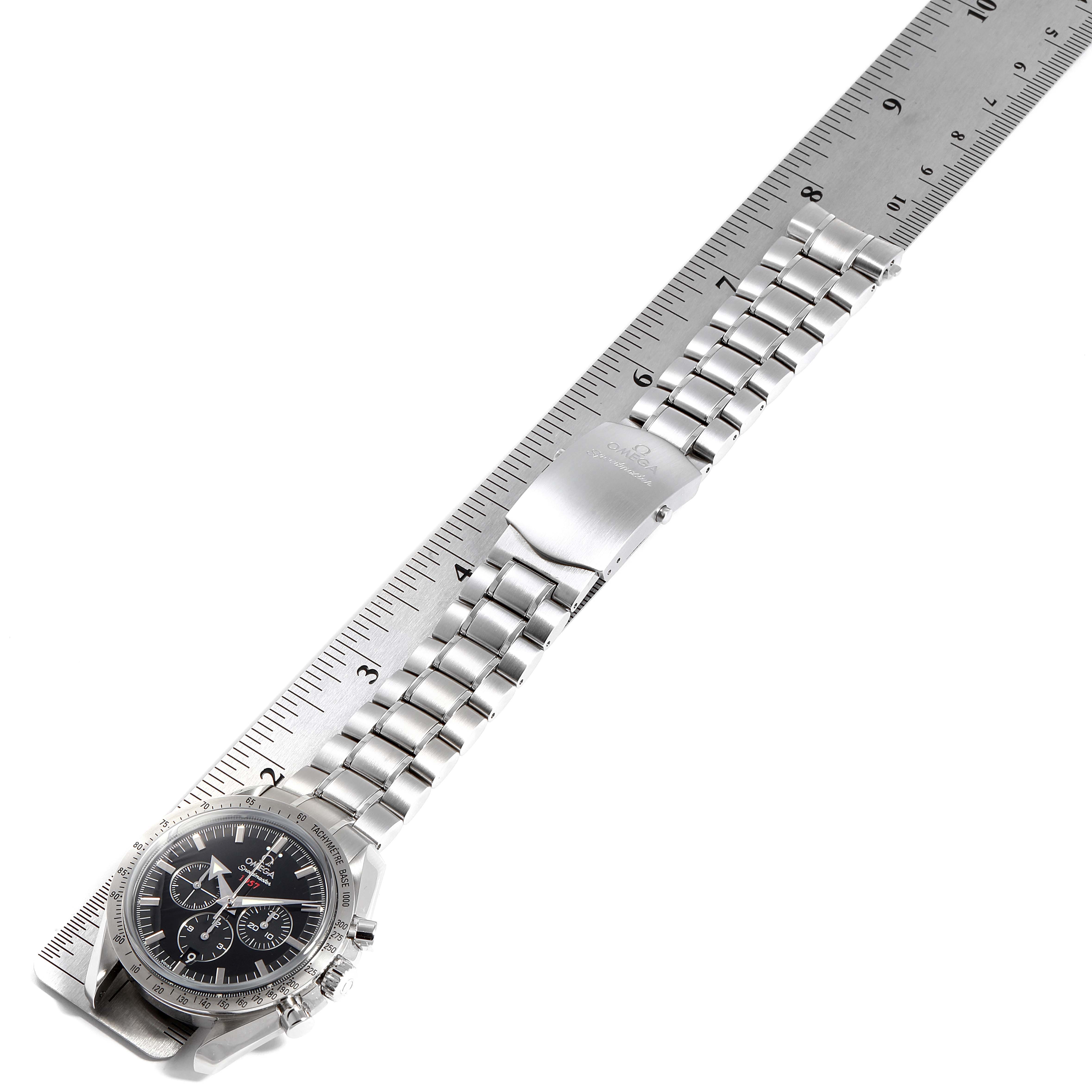 The Omega Speedmaster 321.10.42.50.01.001 Men
s Stainless Steel Black Dial 321.10.42.50.01.001 Men
s Stainless Steel Black Dial watch is shown from a top-down angle, displaying its face, metal bracelet, and clasp along a ruler.