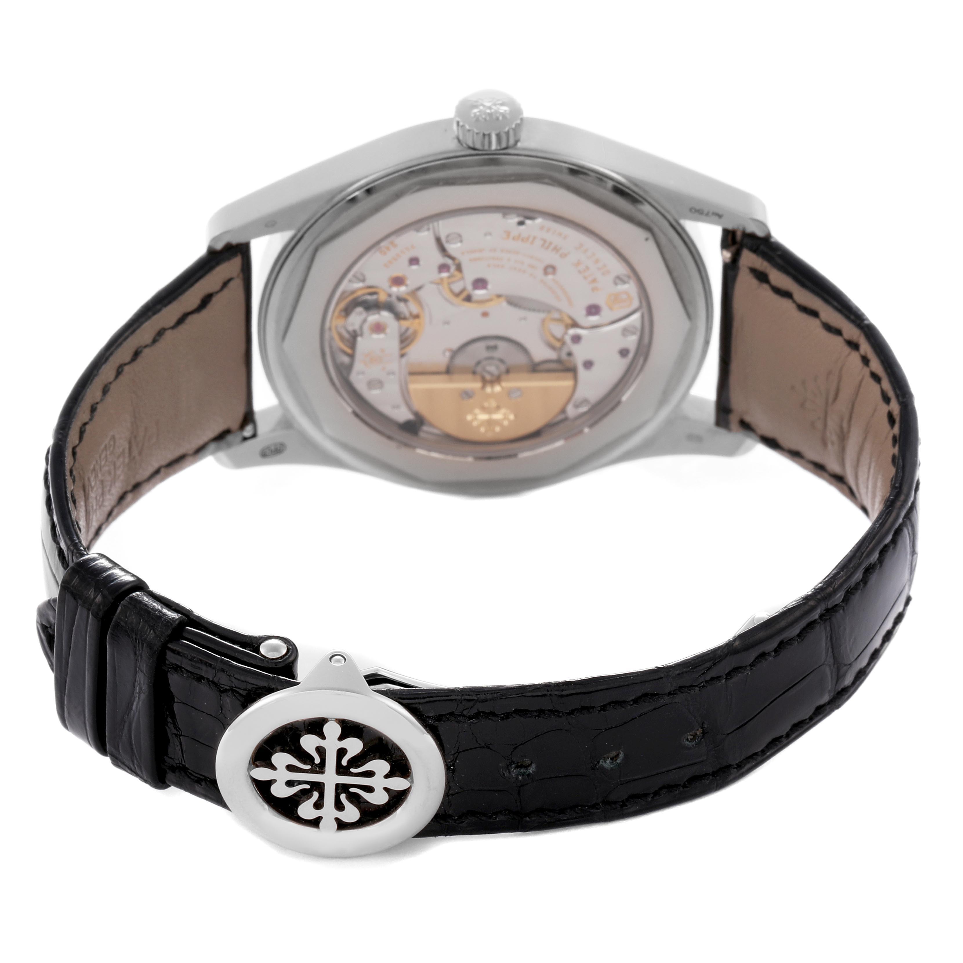 The image shows the back view of a Patek Philippe Calatrava 6006G-001 Men's White Gold Black Dial 6006G-001 Men's White Gold Black Dial, highlighting the movement and leather strap.