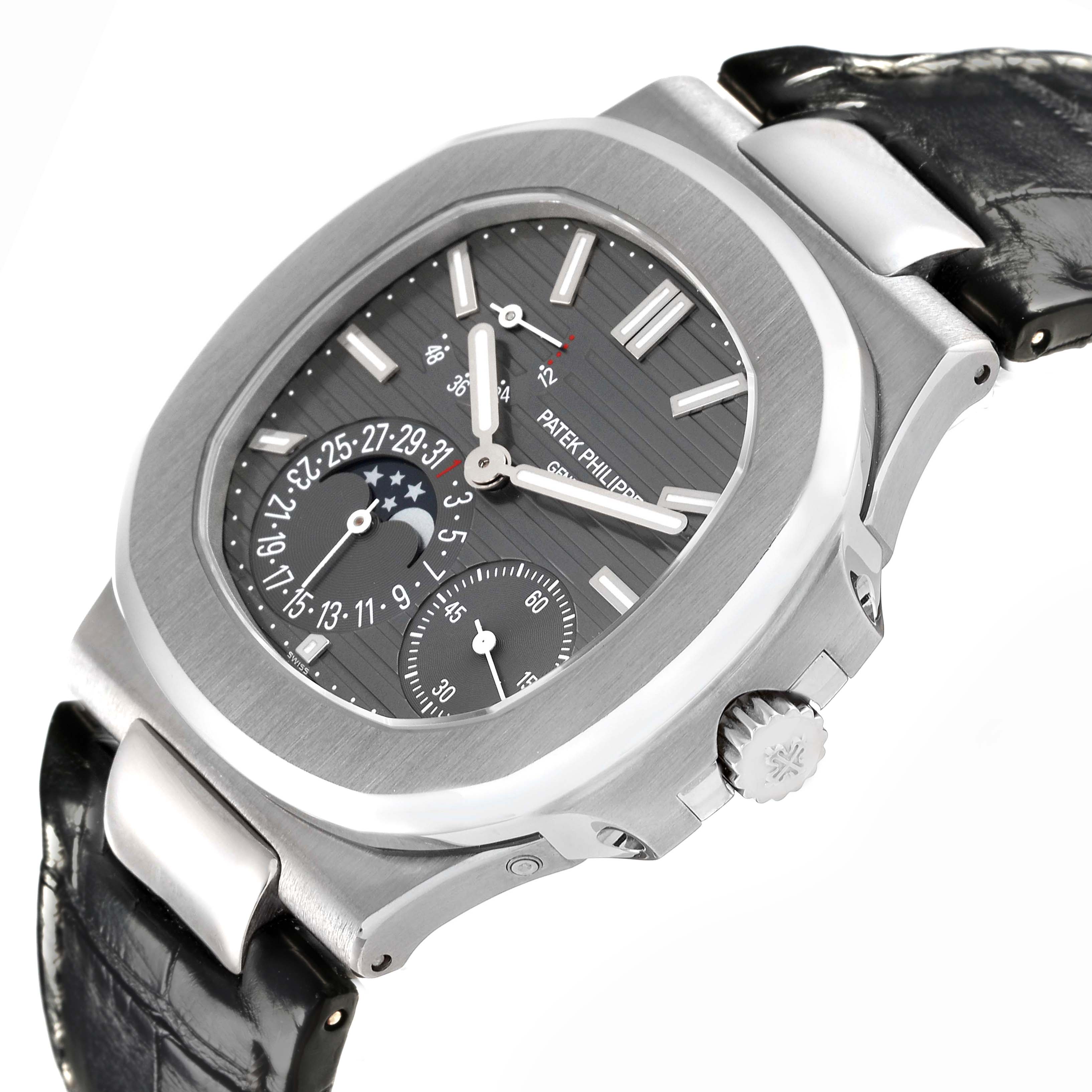 The Patek Philippe Nautilus 5712G-001 Men
s White Gold Grey Dial 5712G-001 Men
s White Gold Grey Dial watch is shown at an angle highlighting the dial, moon phase, subdial, and crown.