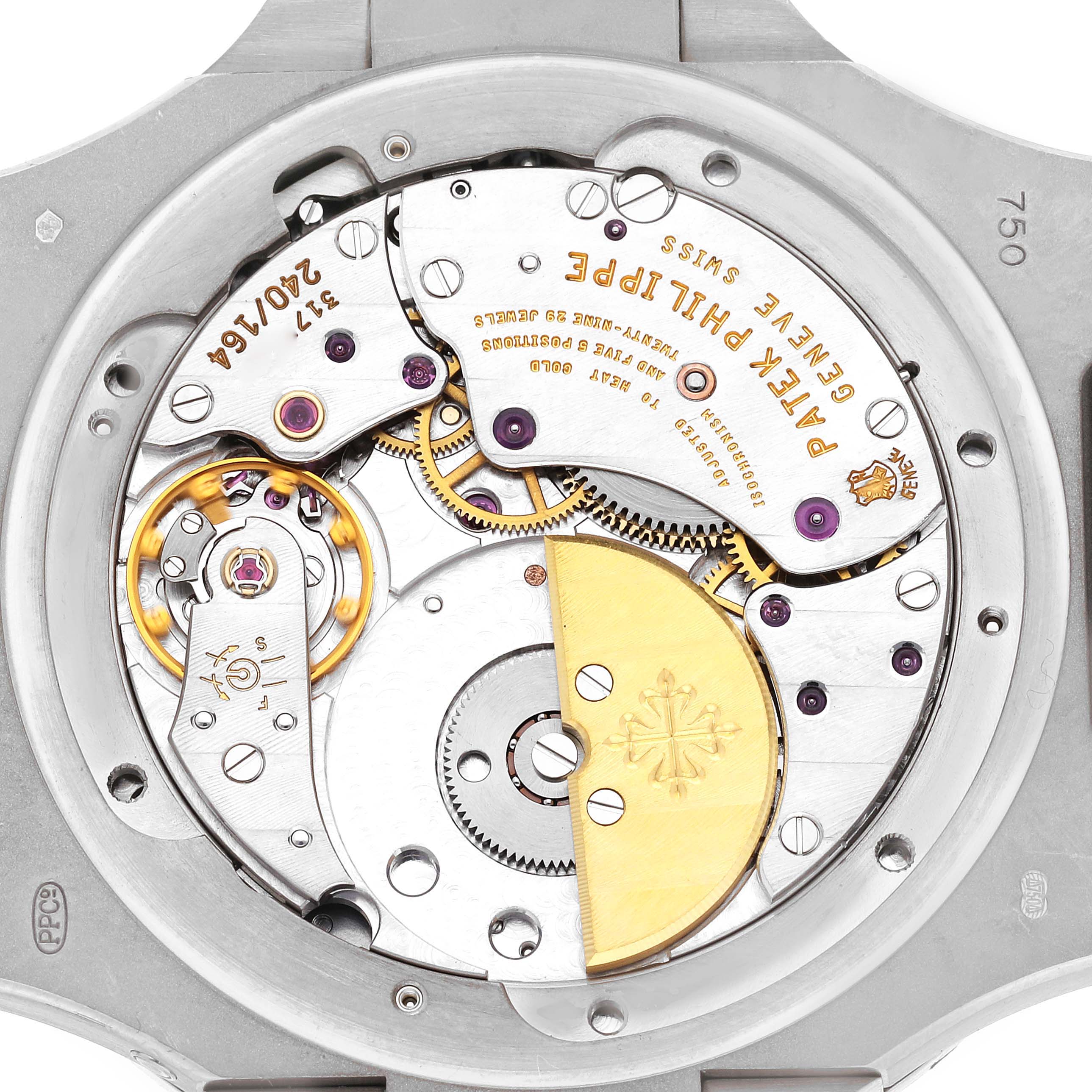 The image shows the back view of a Patek Philippe Nautilus 5712G-001 Men
s White Gold Grey Dial 5712G-001 Men
s White Gold Grey Dial, highlighting its intricate movement and rotor.