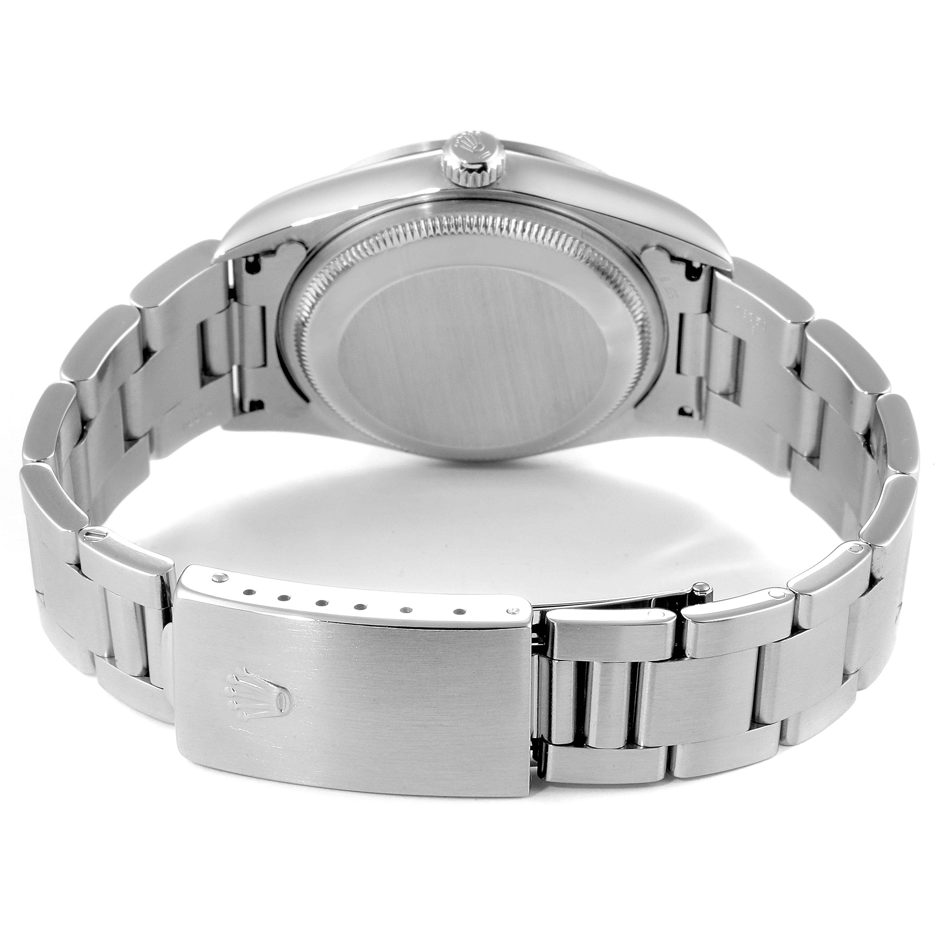 The image shows the back view of a Rolex Date 15200 Men's Stainless Steel Black Dial 15200 Men's Stainless Steel Black Dial model watch, including its caseback and partially opened stainless-steel bracelet.