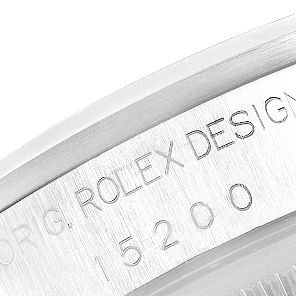 The image shows a close-up of the side view of a Rolex Date 15200 Men's Stainless Steel Black Dial 15200 Men's Stainless Steel Black Dial model, focusing on the engraved serial and design numbers.