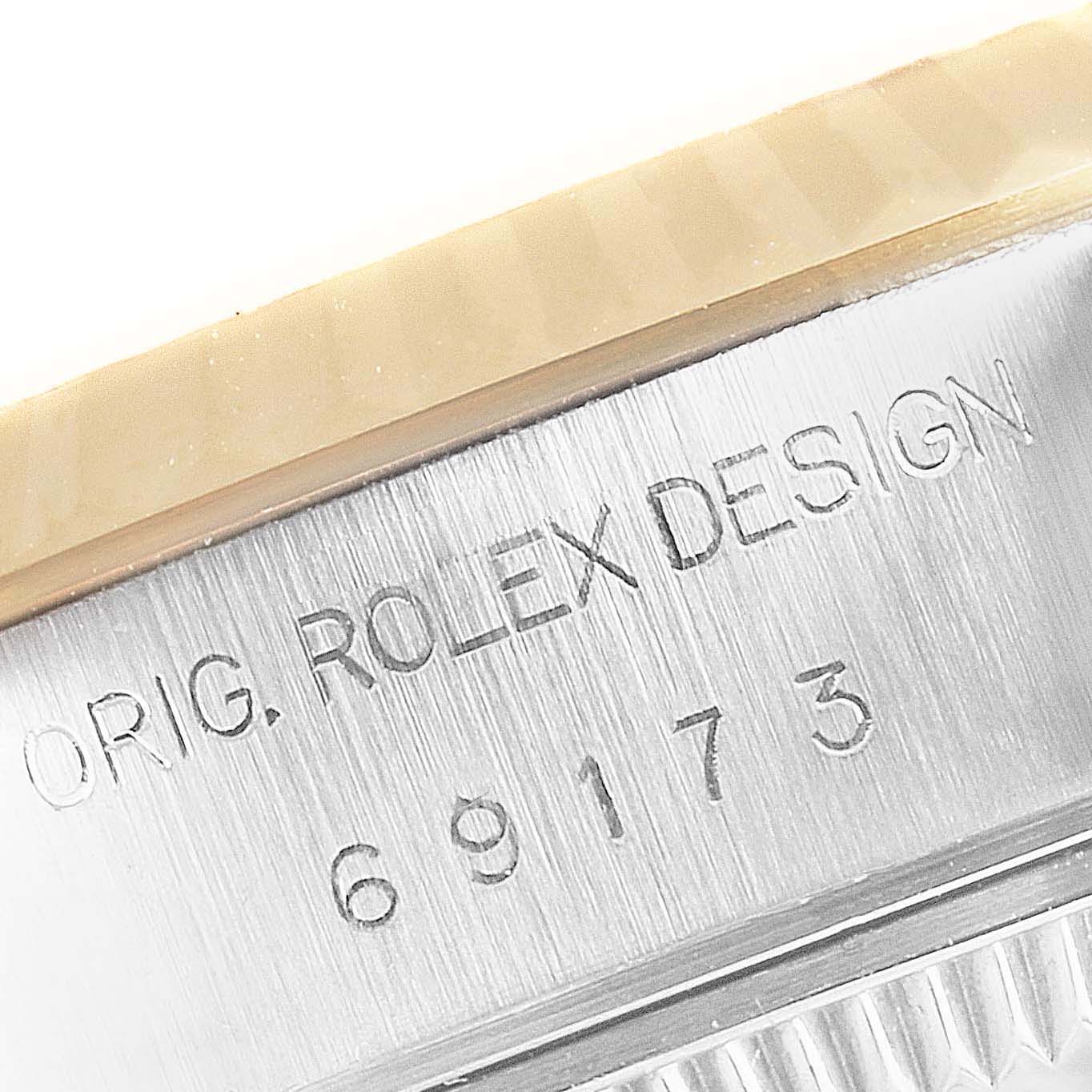This close-up image of the Rolex Datejust 69173 Women
s Steel and Gold (two tone) Champagne Dial 69173 Women
s Steel and Gold (two tone) Champagne Dial shows the model number and "Orig. Rolex Design" inscription on the side of the case.