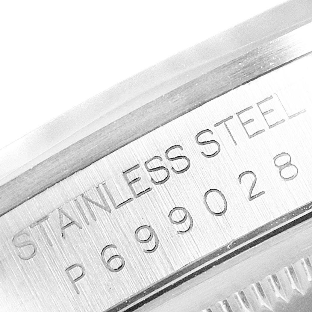 This close-up image shows the engraved serial number and "STAINLESS STEEL" text on the case of a Rolex Datejust 16200 Men
s Stainless Steel Grey Dial 16200 Men
s Stainless Steel Grey Dial watch.