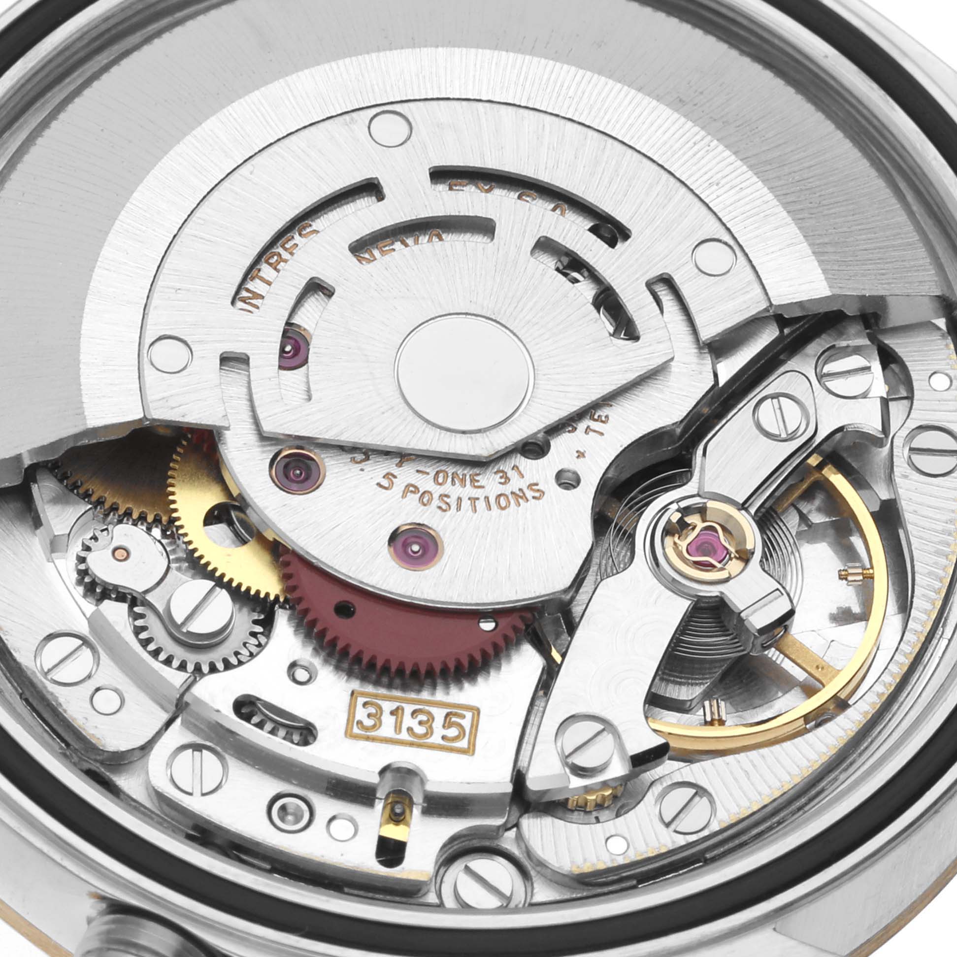 This close-up image shows the intricate internal mechanism of a Rolex Datejust 16233 Men's Steel and Gold (two tone) Black Dial 16233 Men's Steel and Gold (two tone) Black Dial watch, highlighting gears and the 3135 caliber engraving.