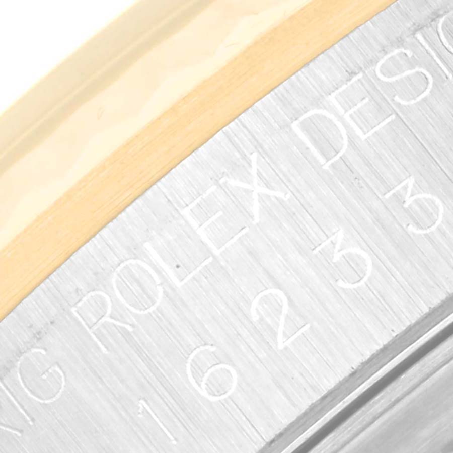 The image shows a close-up of the engraved side of the case back for a Rolex Datejust 16233 Men's Steel and Gold (two tone) Black Dial 16233 Men's Steel and Gold (two tone) Black Dial watch.