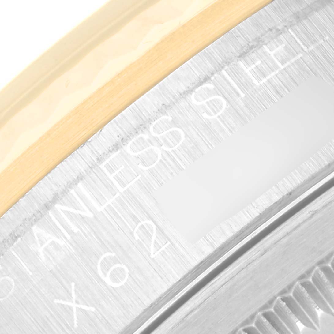 The image shows a close-up of the inscription on the case back of a Rolex Datejust 16233 Men's Steel and Gold (two tone) Black Dial 16233 Men's Steel and Gold (two tone) Black Dial, including part of the bezel.