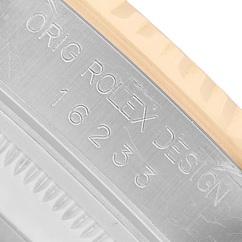 The image shows a close-up of the side engraving on the bezel and case of a Rolex Datejust 16233 Men's Steel and Gold (two tone) Champagne Dial watch.