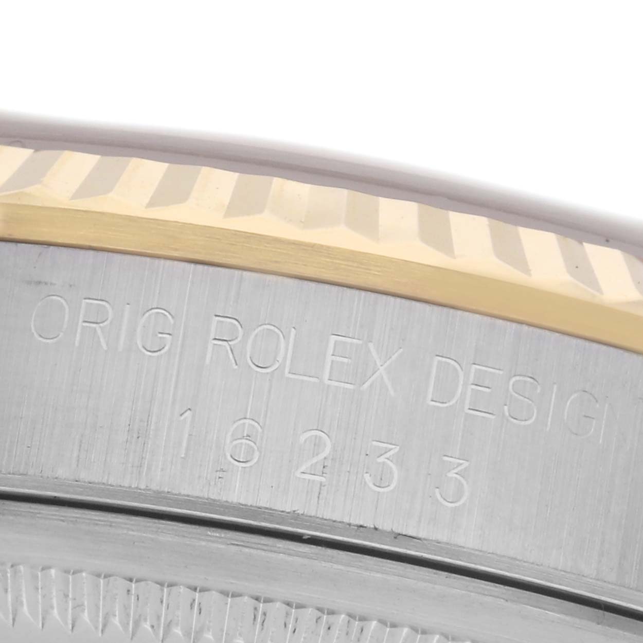 The image shows a close-up of the side of a Rolex Datejust 16233 Men's Steel and Gold (two tone) Champagne Dial 16233 Men's Steel and Gold (two tone) Champagne Dial, highlighting the bezel and engraved model number.