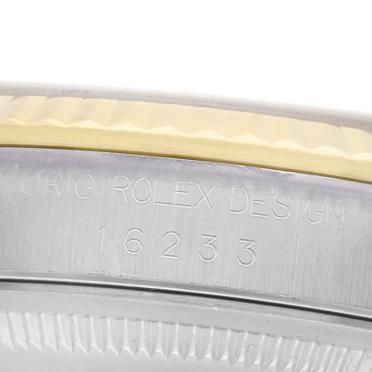 The image shows a close-up of the side of a Rolex Datejust 71081 Men
s Steel and Gold (two tone) Champagne Dial 71081 Men
s Steel and Gold (two tone) Champagne Dial watch, featuring the engraved model number "16233" and part of the fluted bezel.